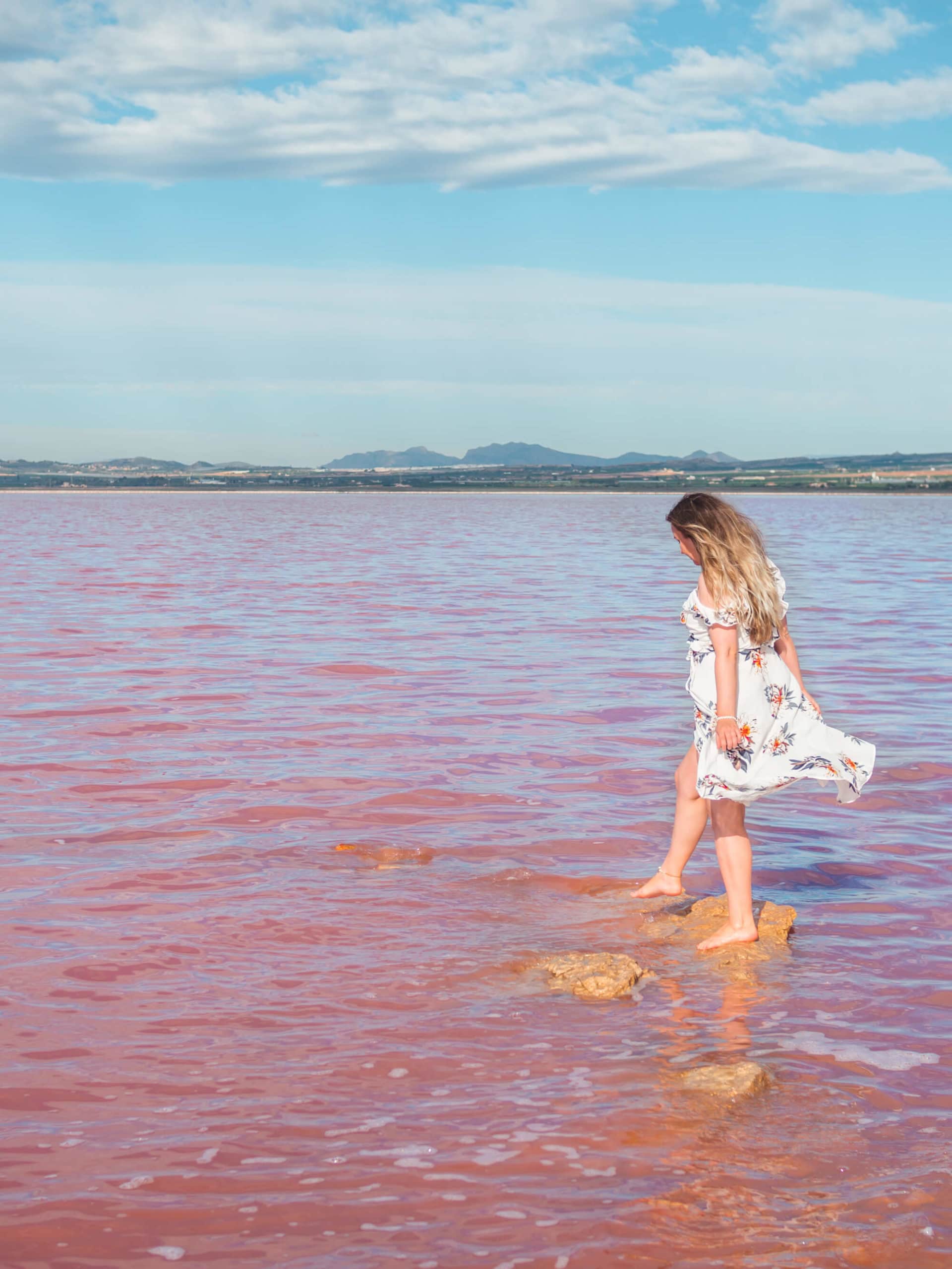 Girl in a white dress at the stunning Pink Lake in Torrevieja Spain