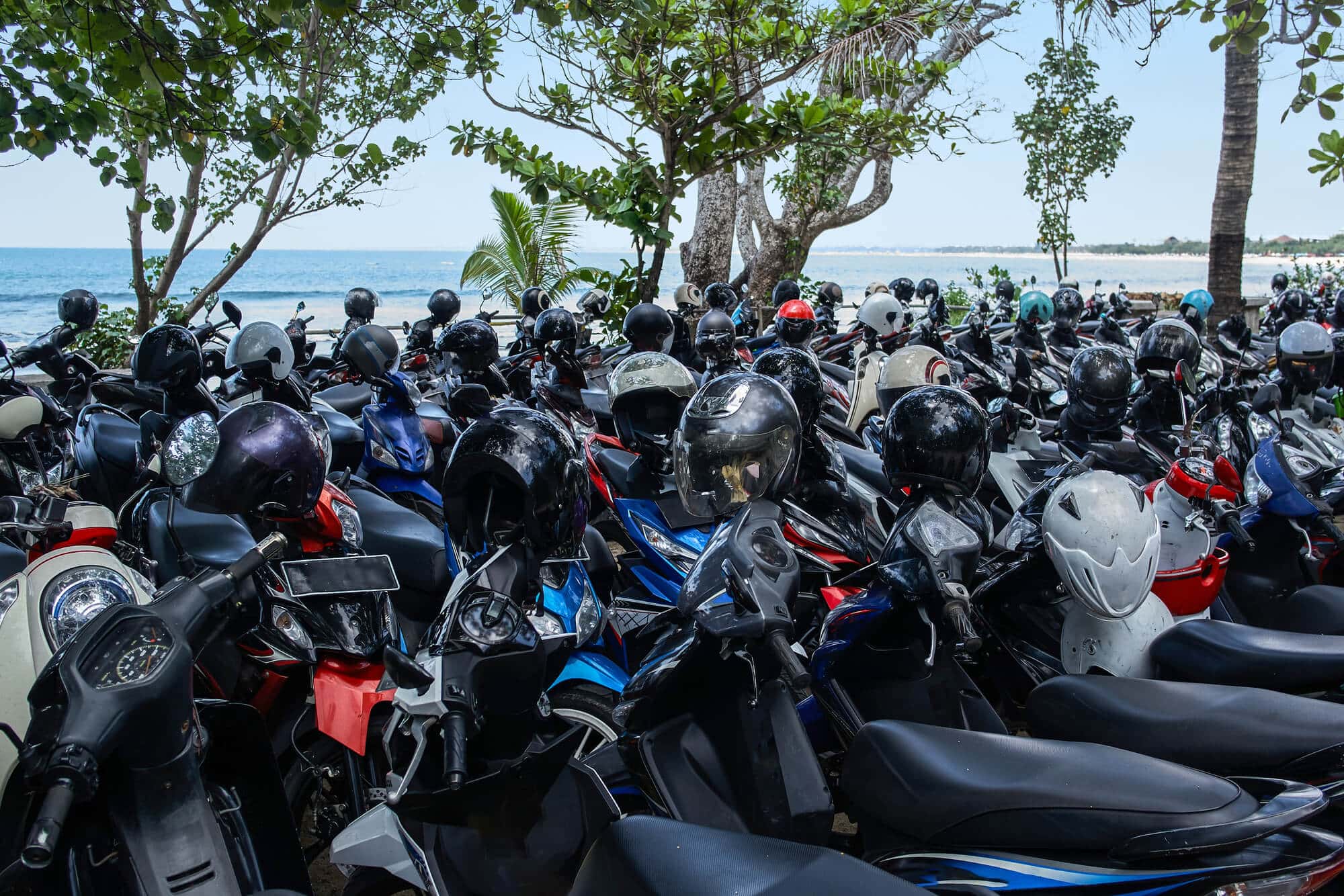 A sea of scooters at Kuta Beach, common scams in Bali