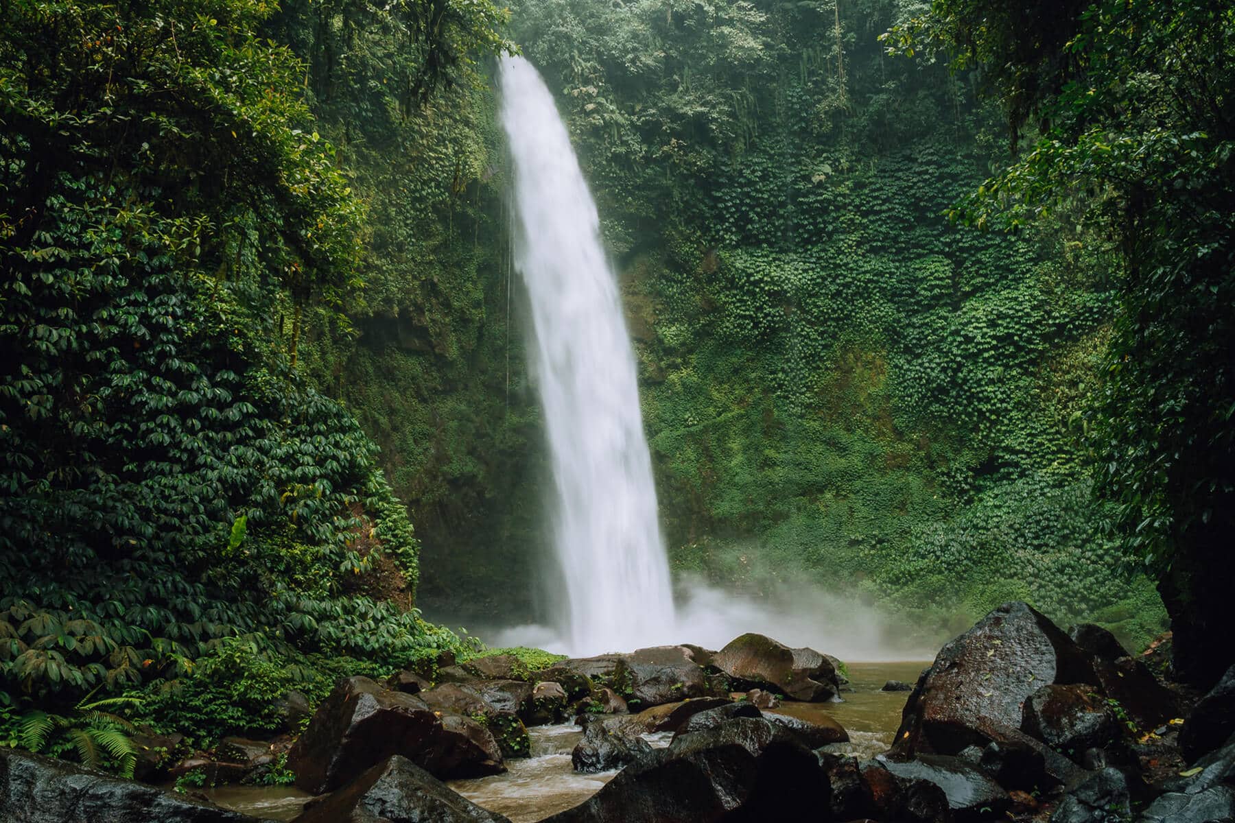 A guide to all the best waterfalls in Ubud Bali - View of the powerful Nungnung Waterfall
