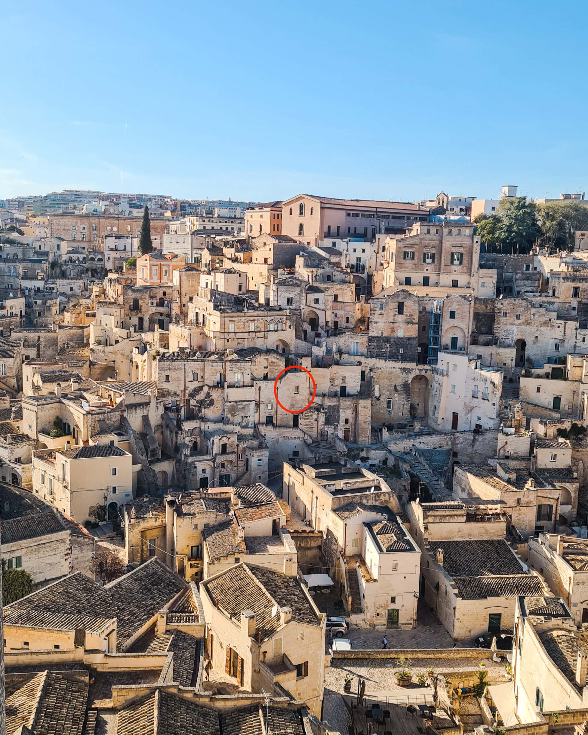 The stone town of Sassi Di Matera set against a purple sky at sunset - The best hotel view in Matera