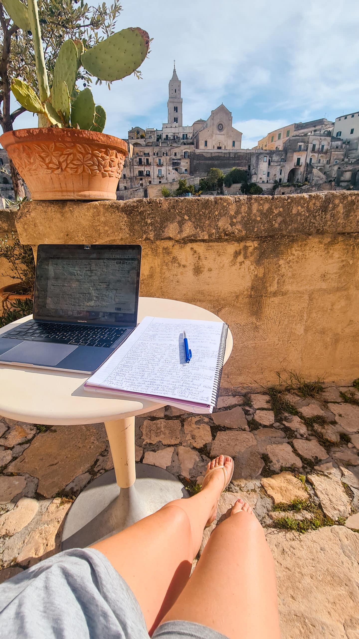 Digital Nomad working in front of the incredible view at Hotel Sassi in Matera