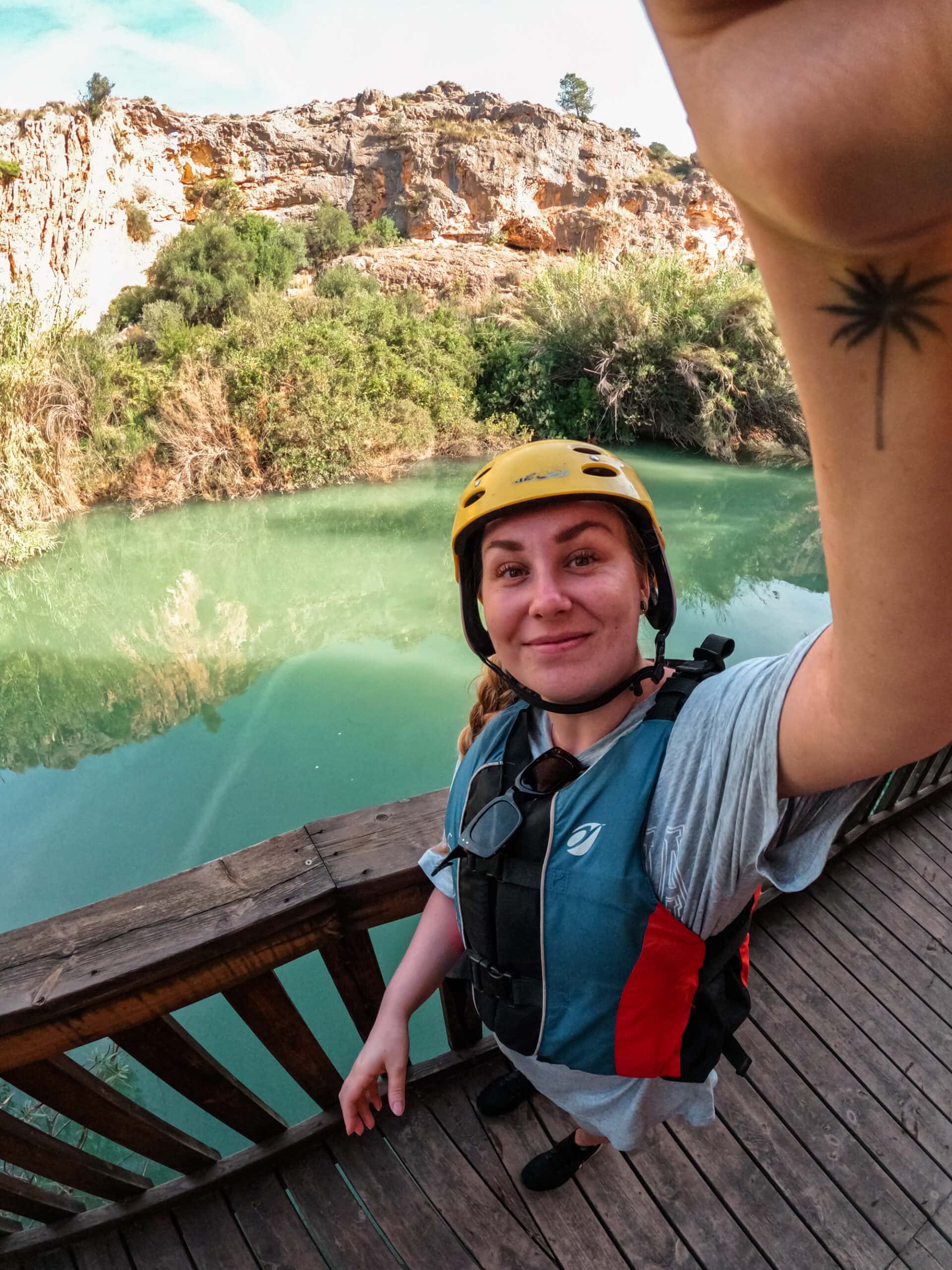 Rafting the Segura River in Murcia, Spain. Talking a selfie with the stunning green river and mountain range in the background.