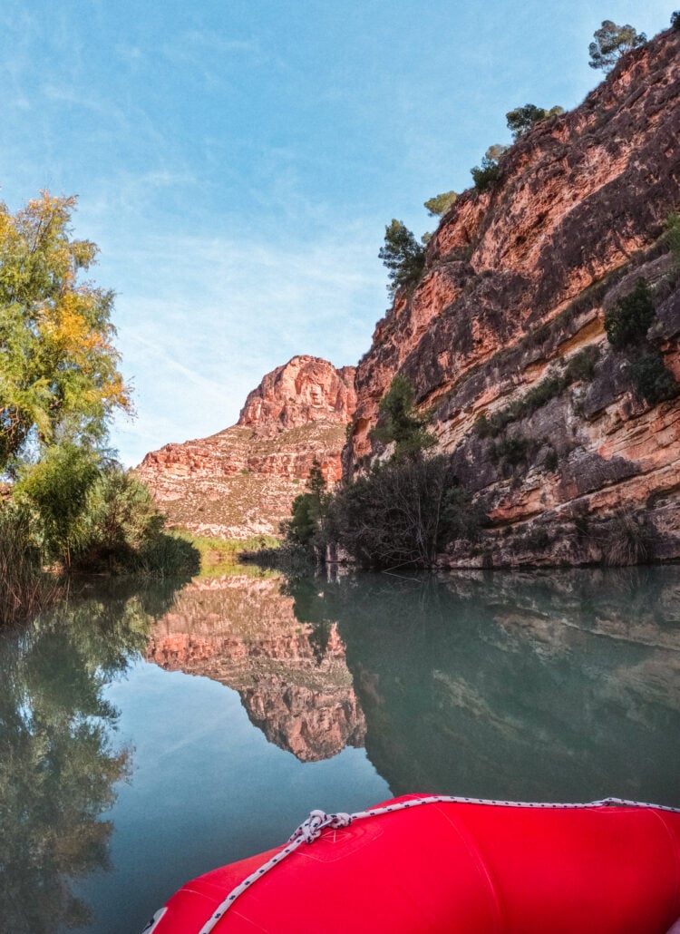 Rafting the Segura River in Murcia, Spain. Stunning mountain range reflection in the green river.