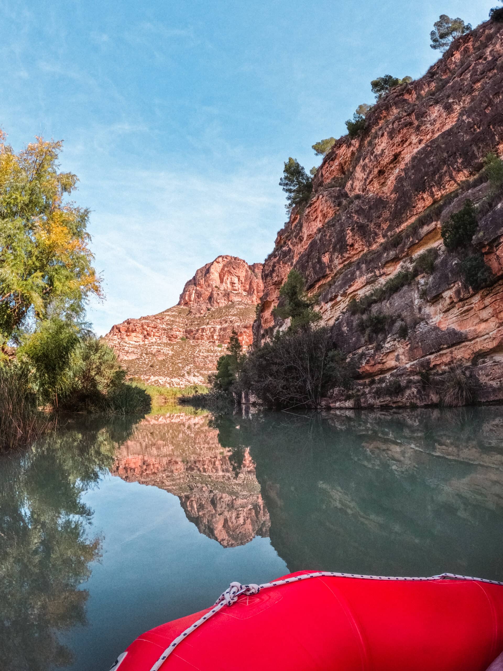 Rafting the Segura River in Murcia, Spain. Stunning mountain range reflection in the green river.