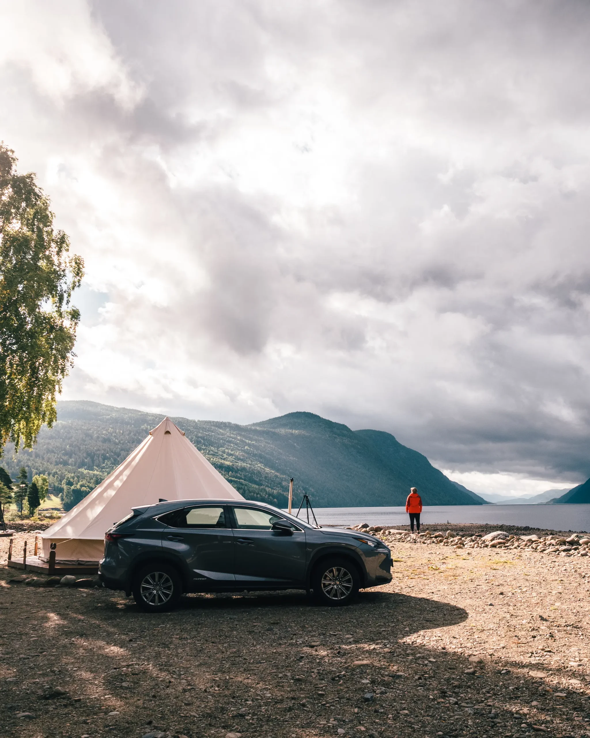 Grey Lexus in front of a glamping tent by the ocean on a gloomy day in Norway. How I manifested my dream car.