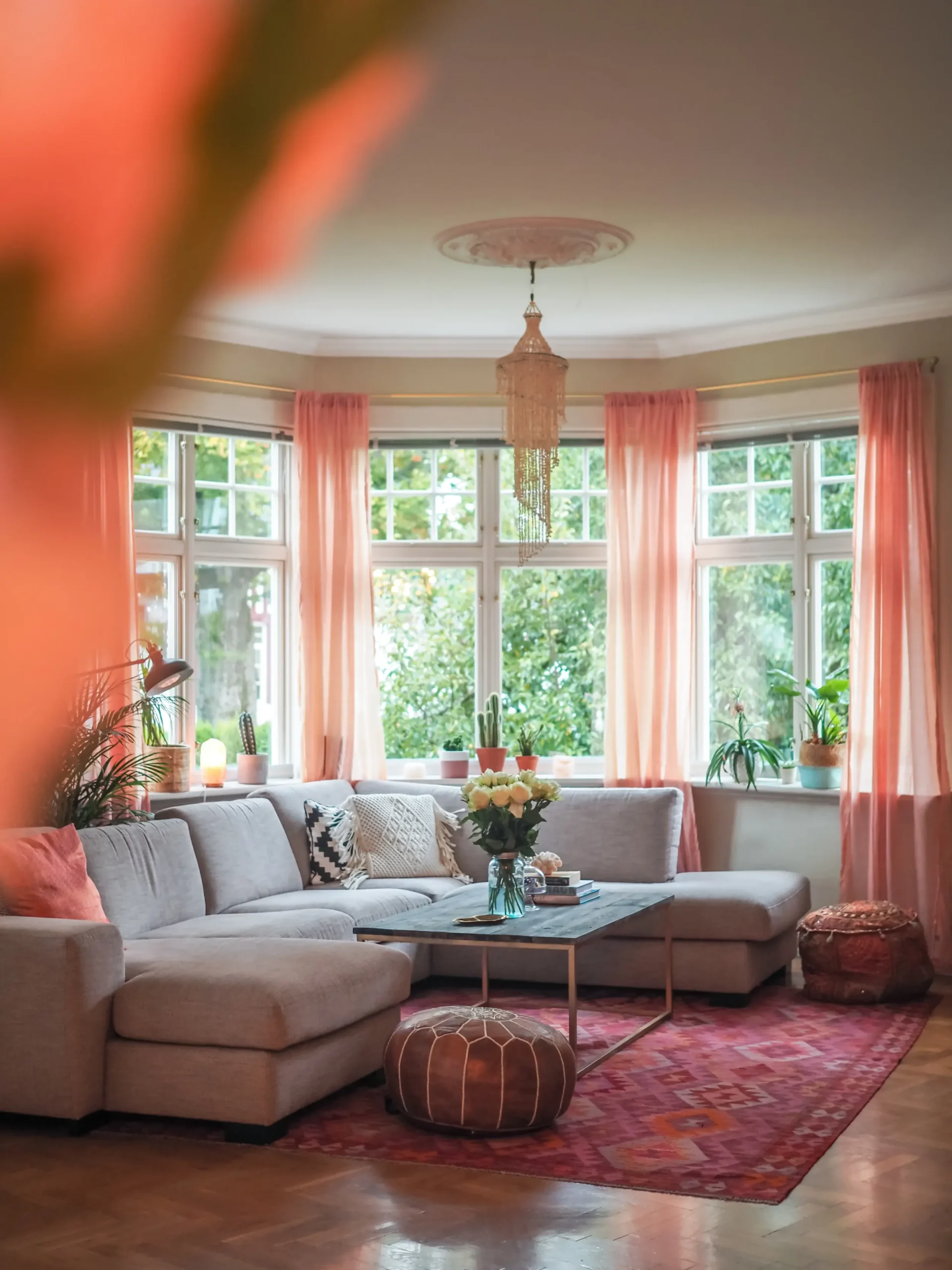Manifest your dream house and interior, herringbone floor, large bay window with pink curtains, Moroccan pouf, pink Kilim rug, ceiling rosette and seashell chandelier.