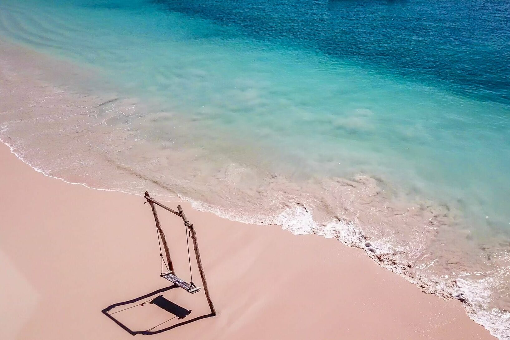 Aerial view of a swing on Pink Beach near Kuta Lombok