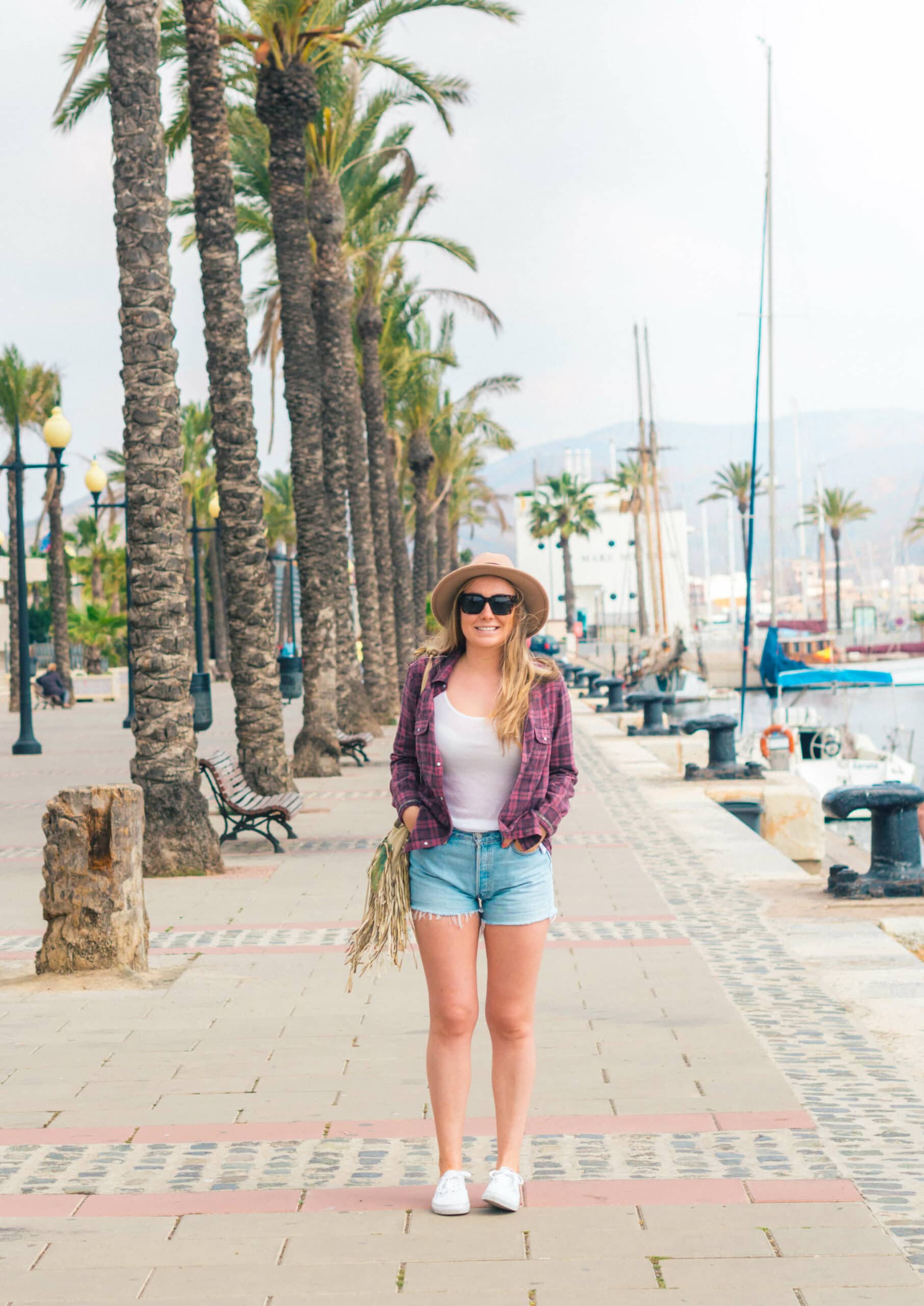 Girl in the palm tree lined cruise port of Cartagena, Spain