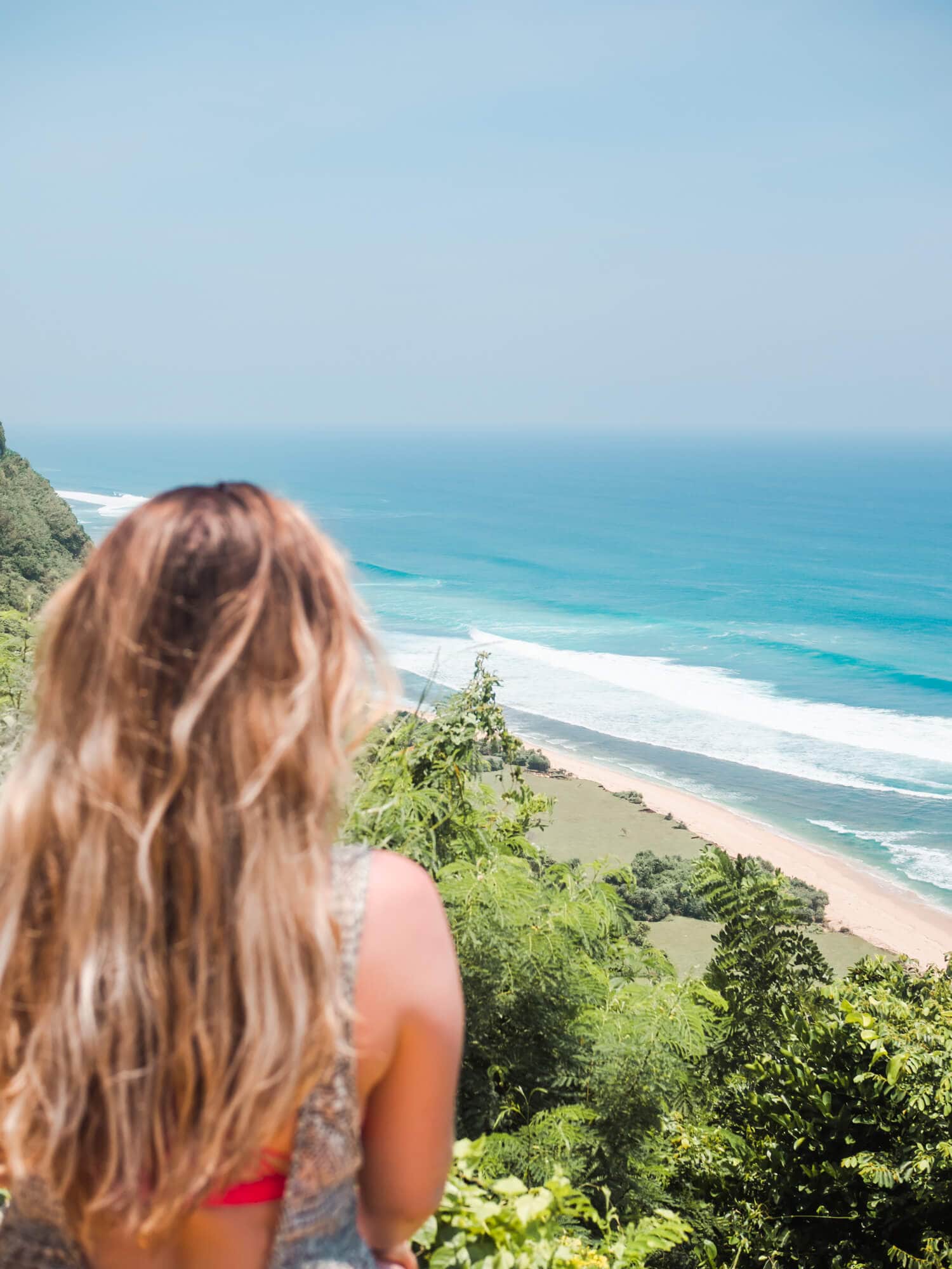 Girl looking out over Nyang Nyang Beach, one of the places you have to include in your Bali Bucket List