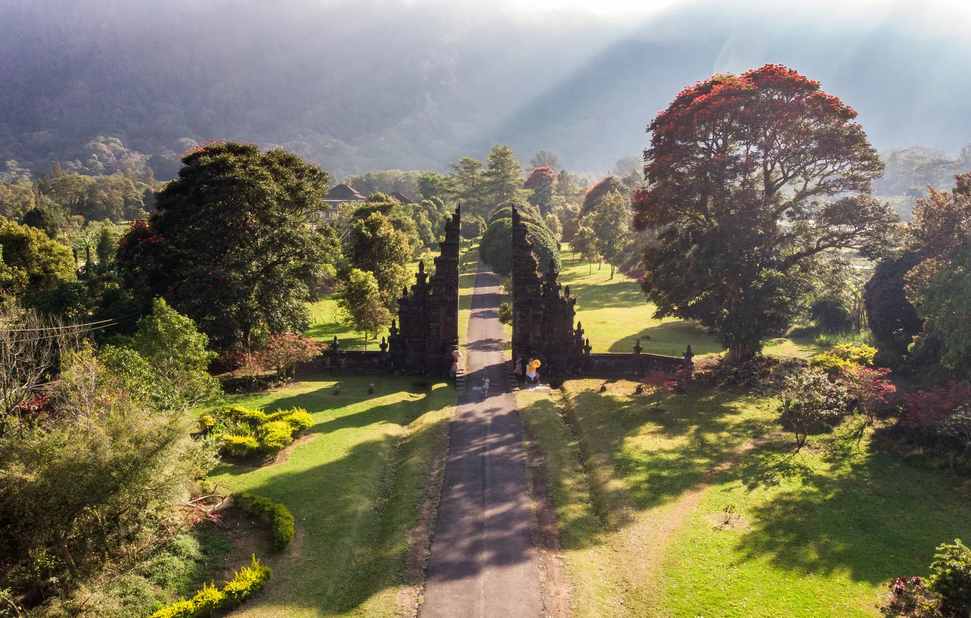 View form above of Handara Gate surrounded by greenery with the sun shining in, one of the top things to do in Bali.