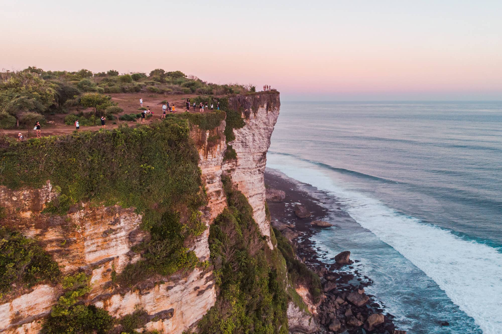 Overview of Karang Boma Cliff in Uluwatu whre people are watching the sunset