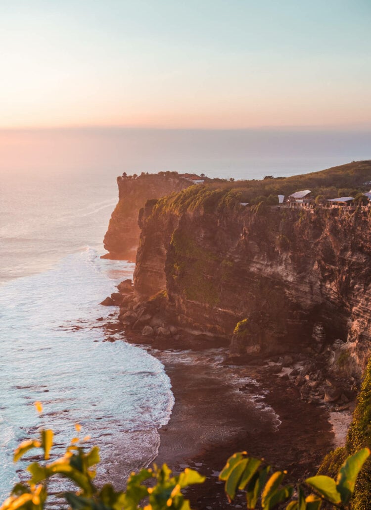 View of the Uluwatu Cliffs from Karang Boma Cliff viewpoint at sunset in Bali.