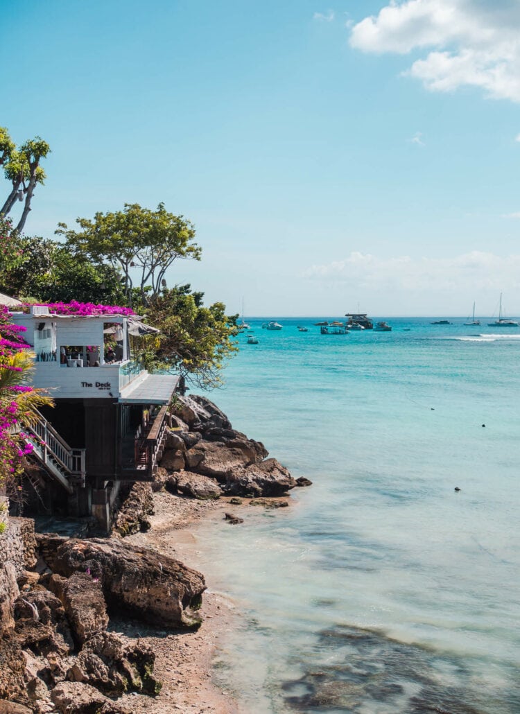 View of The Deck Restaurant covered in pink Bougainvillea along the Boardwalk in Jungut Batu on a day trio to Nusa Lembongan.