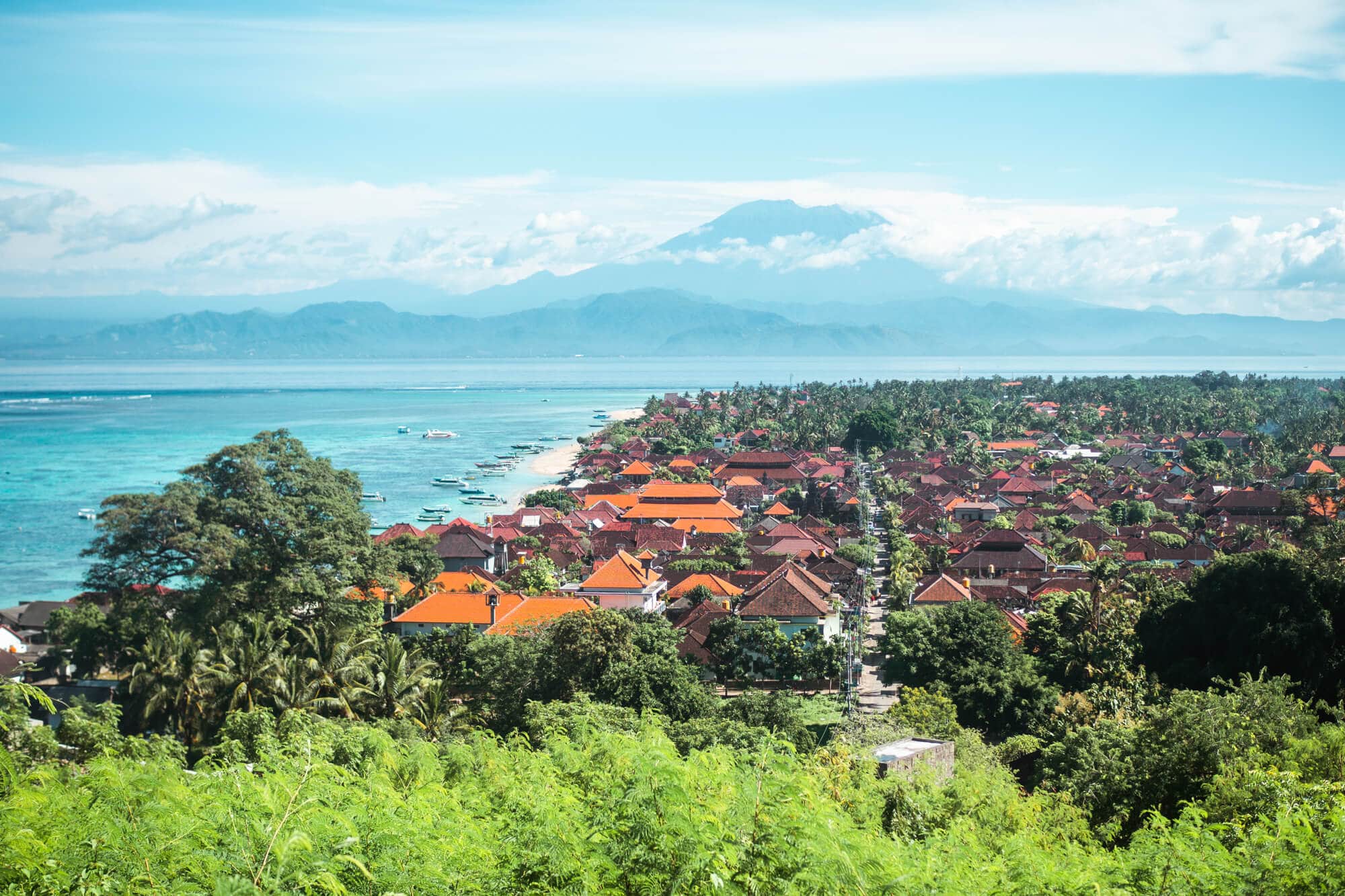 View of Jungut Batu Village with Bali's Mount Agung in the background on a day trip to Nusa Lembongan. A must during your two weeks in Bali.