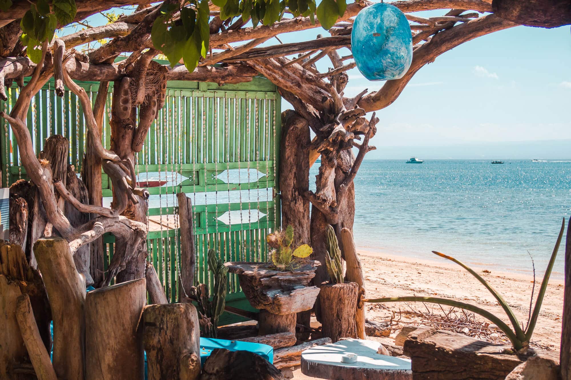 Boho drift wood seating area at Agung Beach Club up by the Mangrove Forest, perfect for a day trip to Nusa Lembongan.