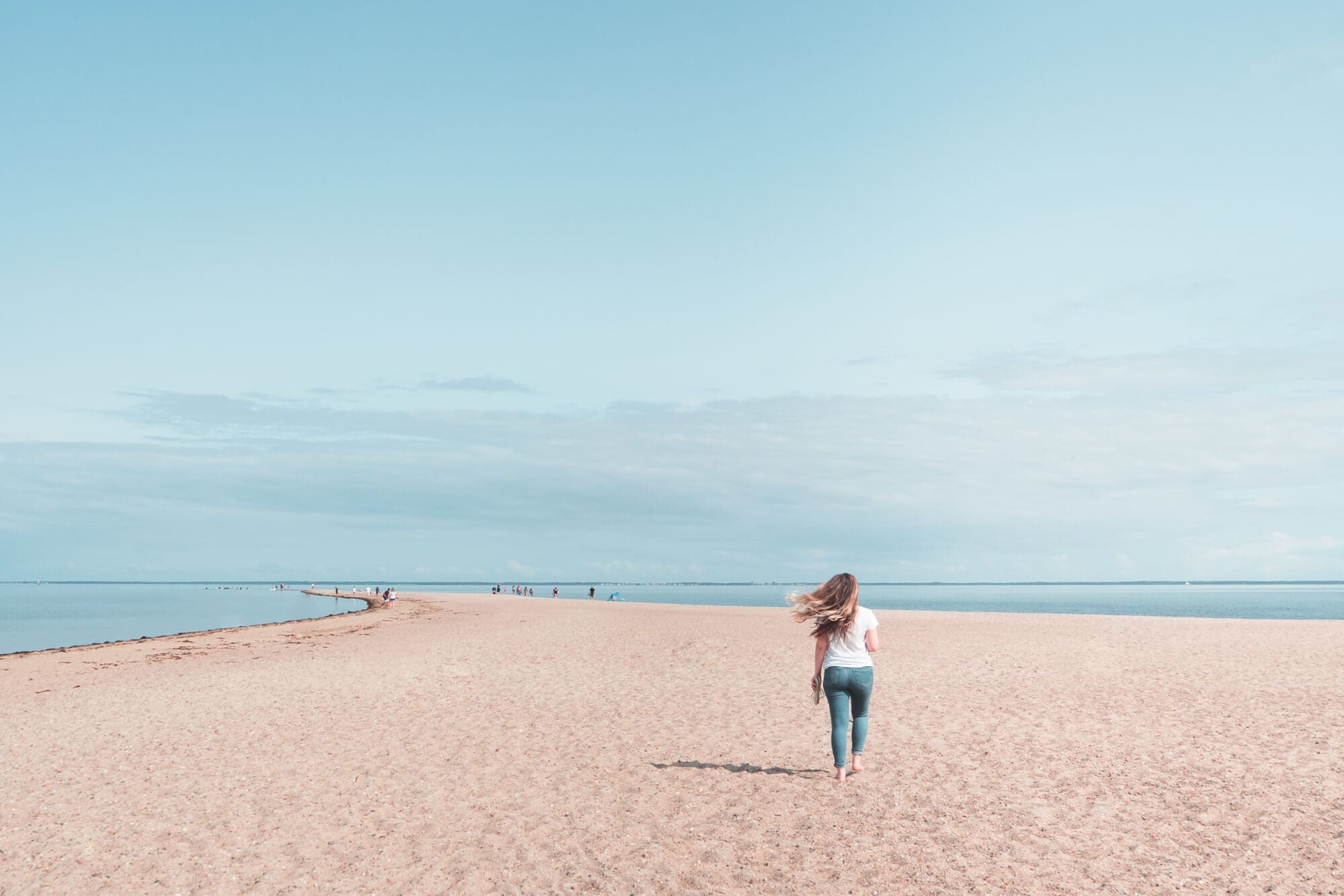 Girl walking along the beautiful Rewa Beach on a sunny dau - Best day trips from Gdansk