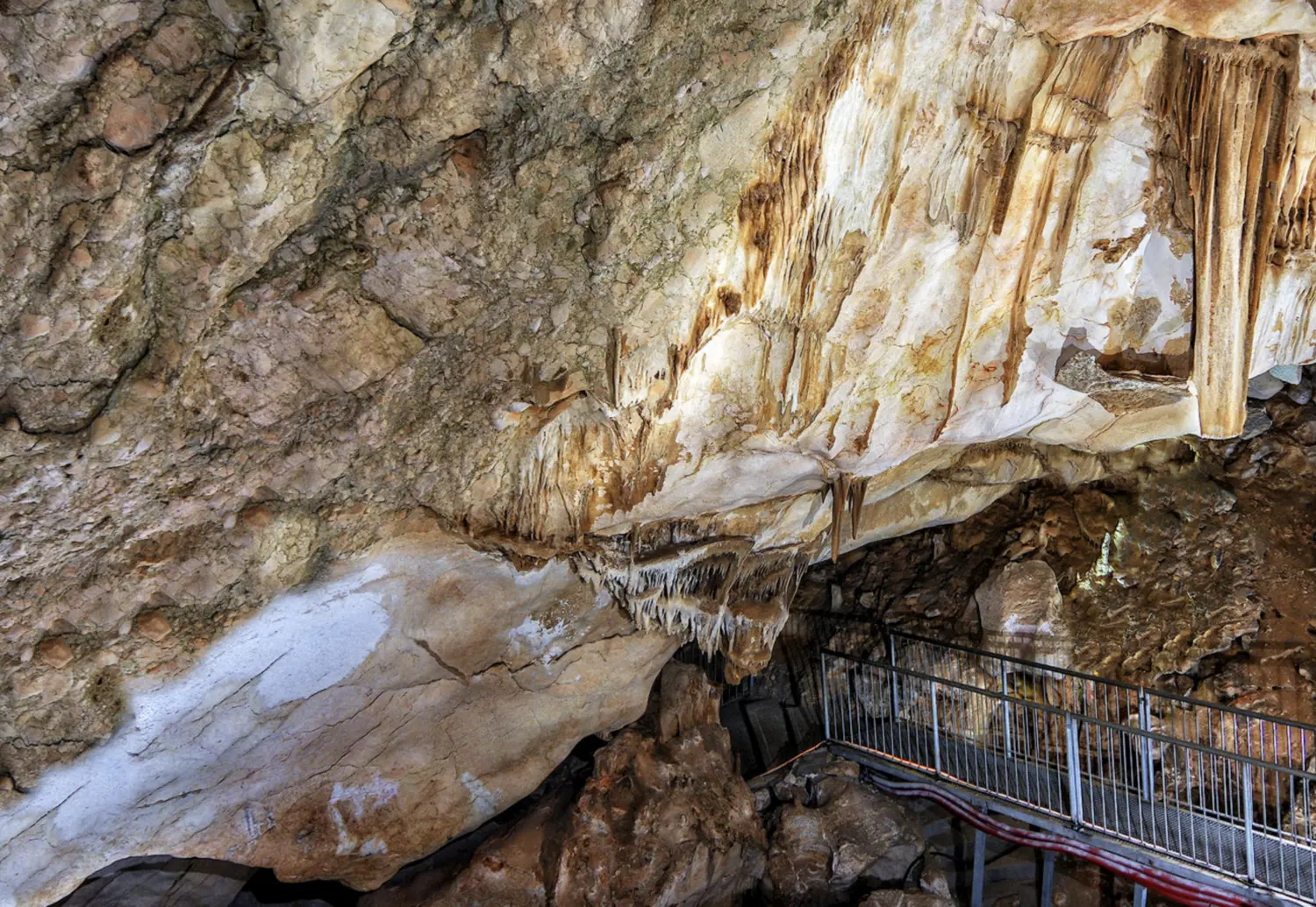 Bridge running under stalagmites in Cueva del Puerto, one of the top things to do in Murcia Spain.