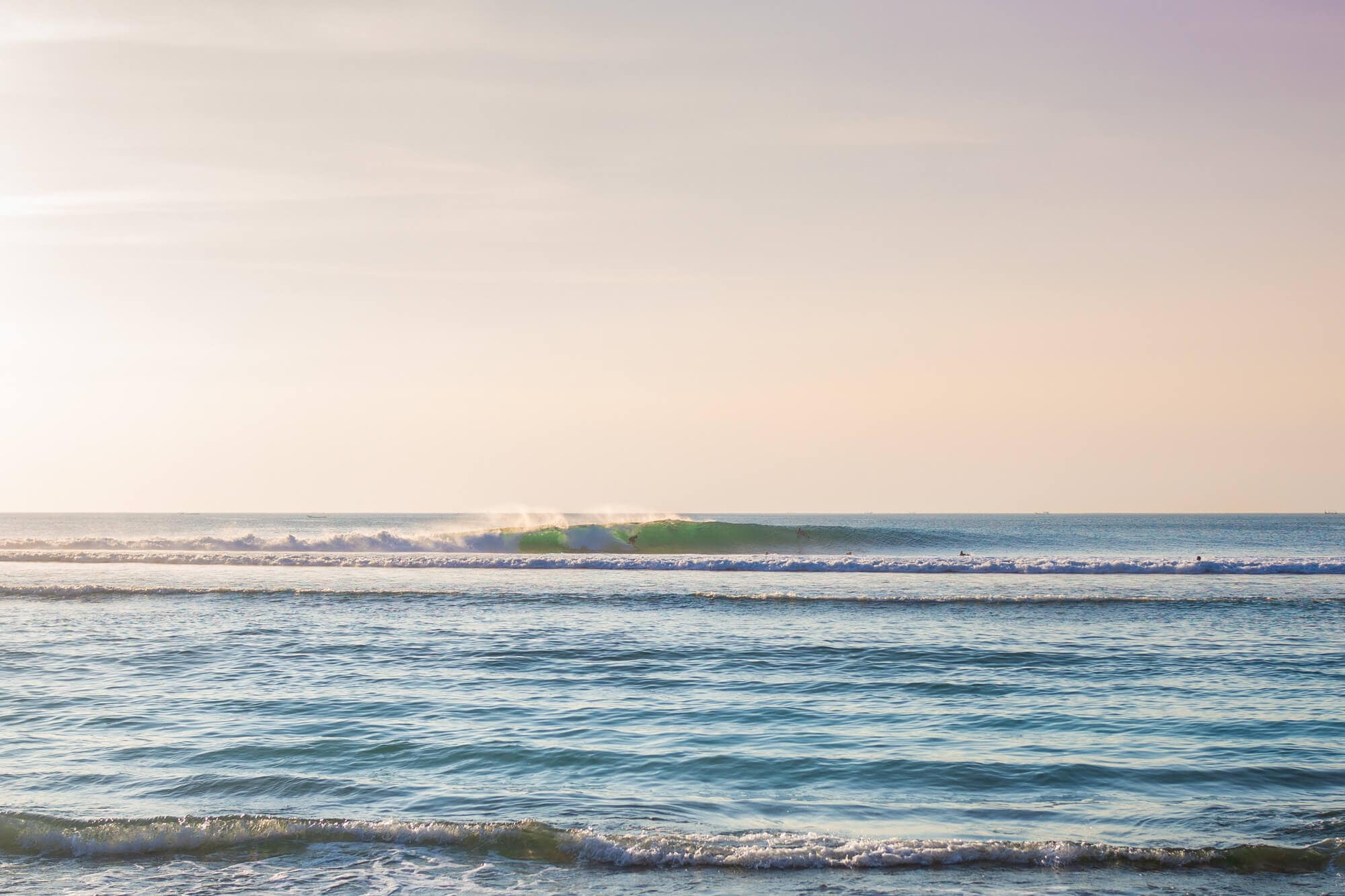 Surfer on a wave in Bingin early in the morning, one of the best places in Bali for a surf and yoga retreat