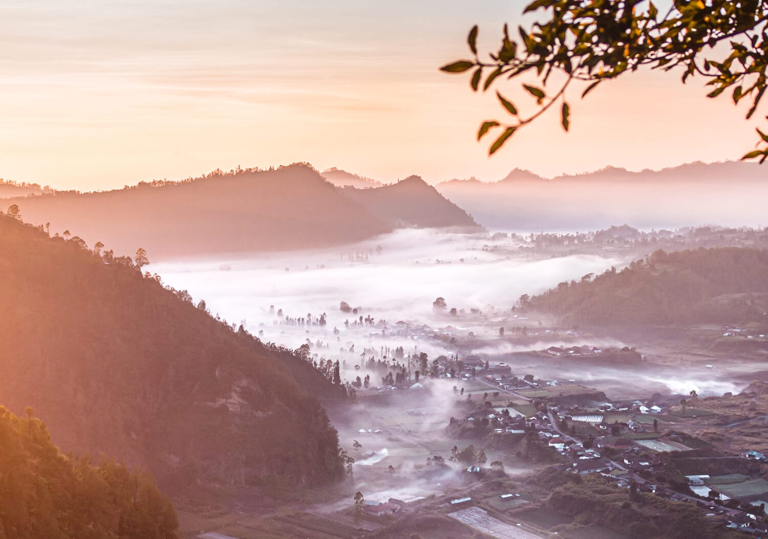 View over Pinggan Village covered by white fog at sunrise in North Bali during the rainy season.