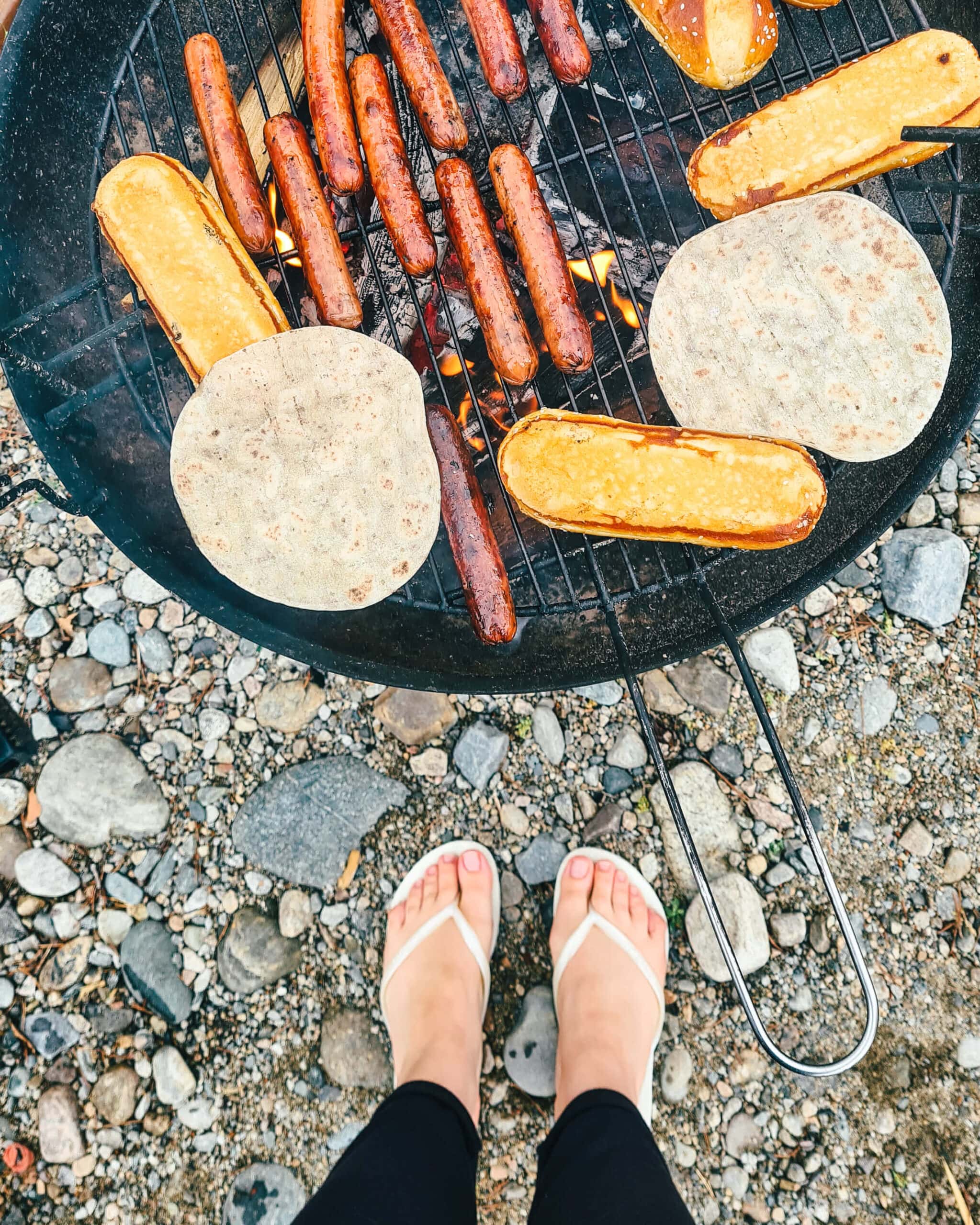 Grilling hot dogs on a public grill to cut down on travel costs in Norway.