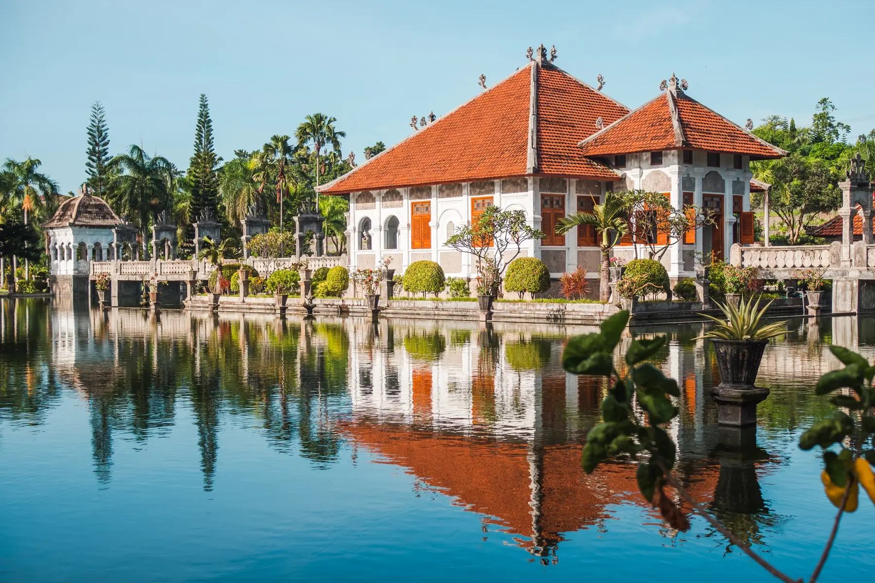 The main building at Taman Ujung reflecting in one of the pools, a hidden gem in Bali.