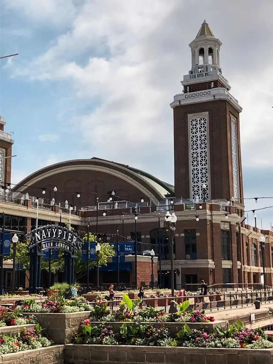 The brown brick Navy Pier with a tower during an architectural river cruise in Chicago.