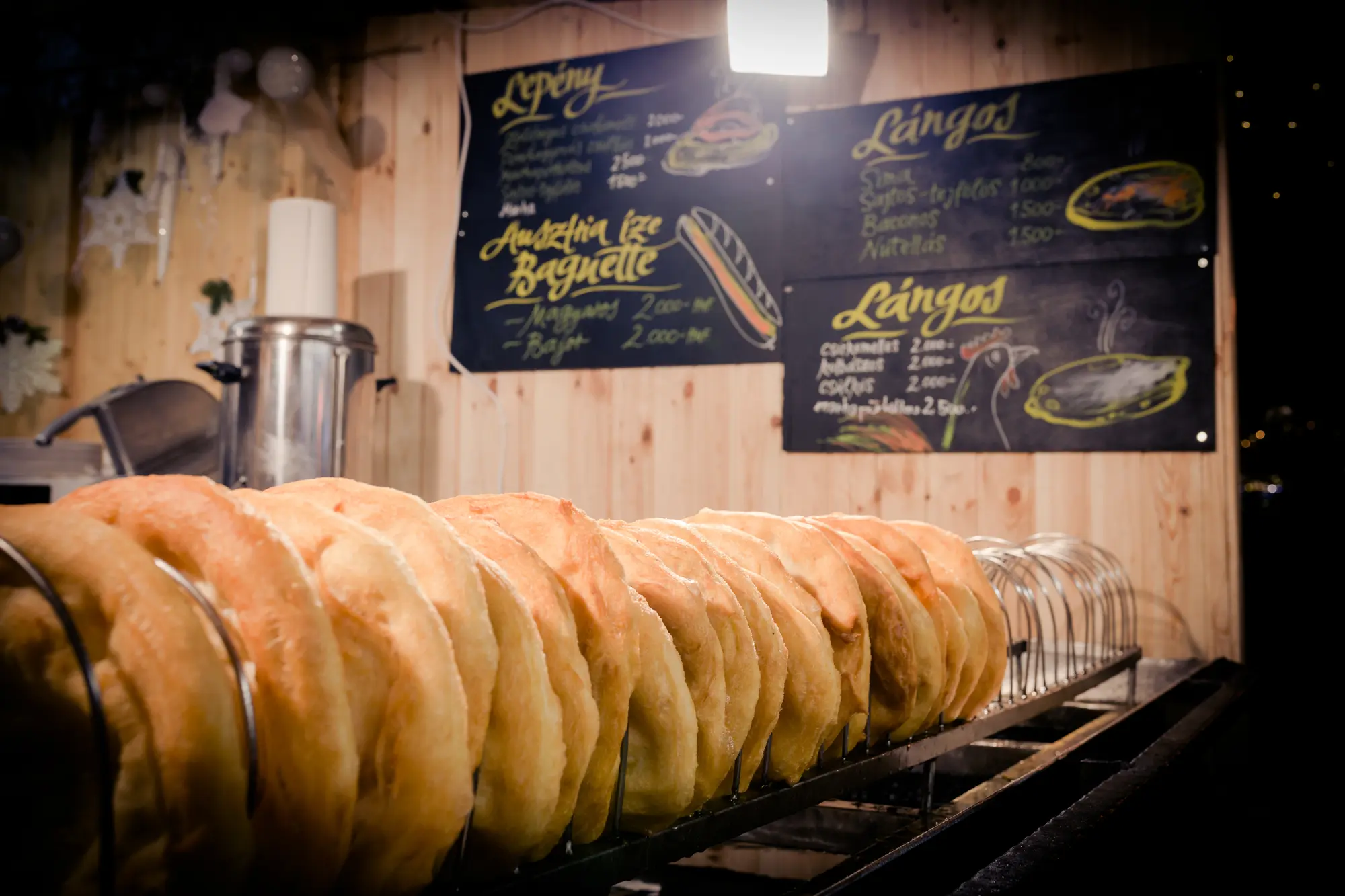 Row of fried Lángos at a Christmas market stall in Budapest.