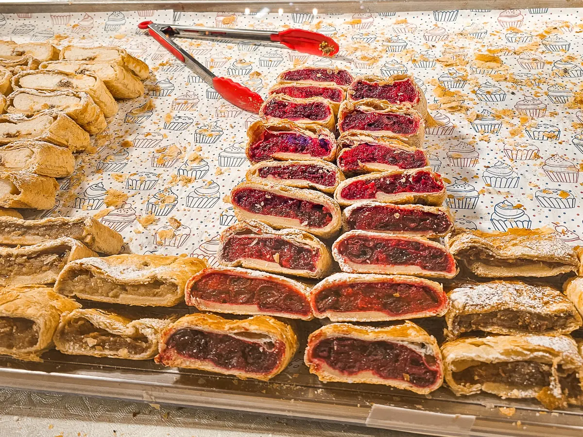 Tray of strudel pastry with red and brown filling, best street food in Budapest.