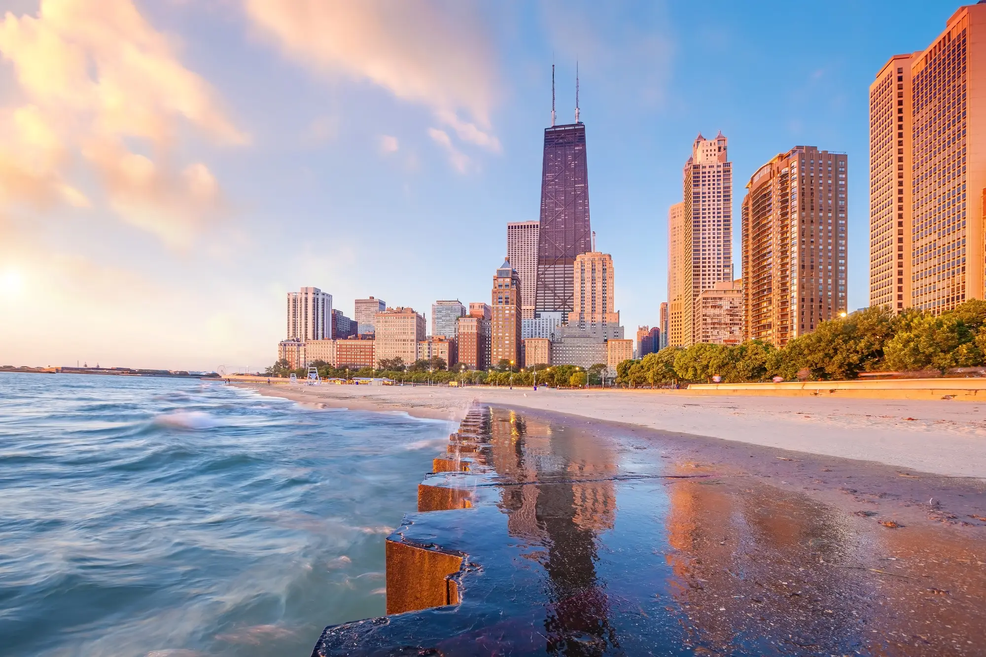 John Hancock Center, a skyscraper with two antennas on top in the Magnificent Mile, seen from Concrete Beach, one of the best areas to stay in Chicago.