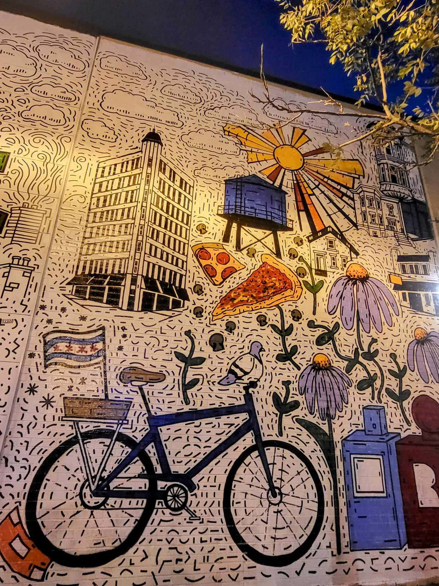 Mural of a bike, pizza and an old building on a white wall in Wicker Park, one of the best areas to stay in Chicago for first-timers.