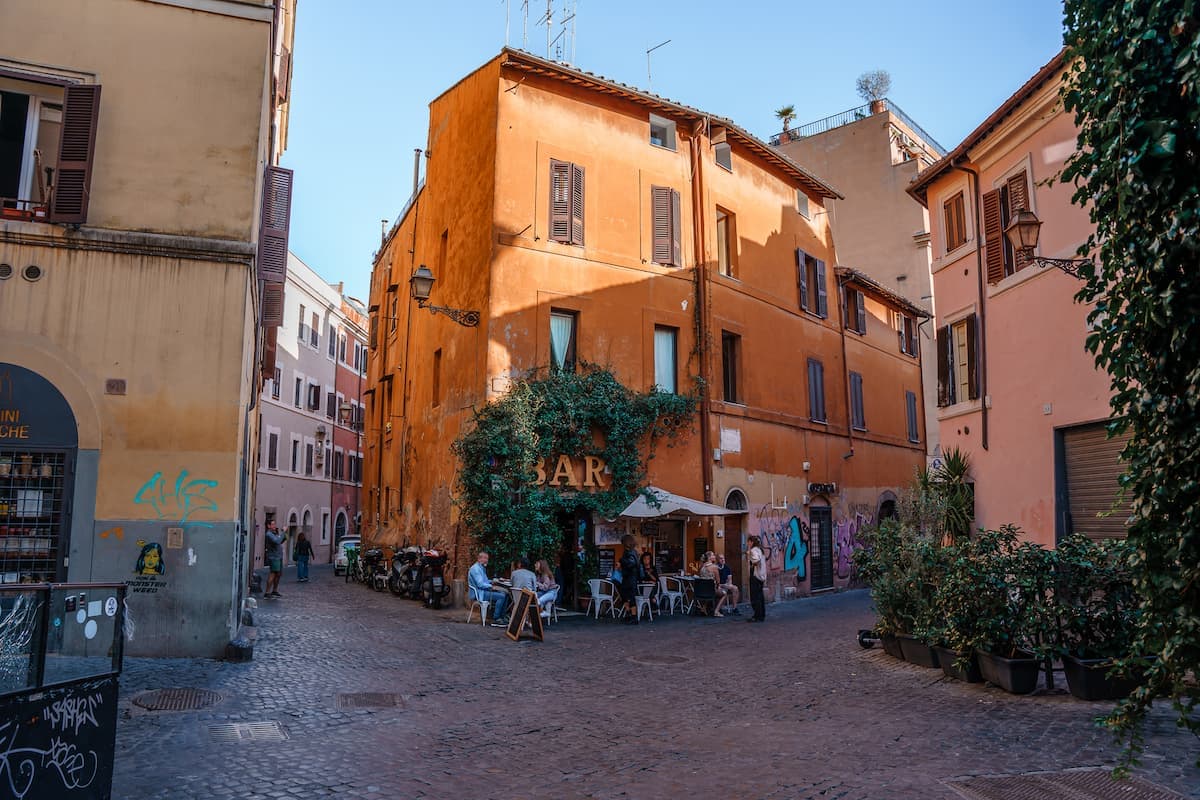 Bar in an orange building and cobblestone alleys in Trastevere, is it safe in Rome?