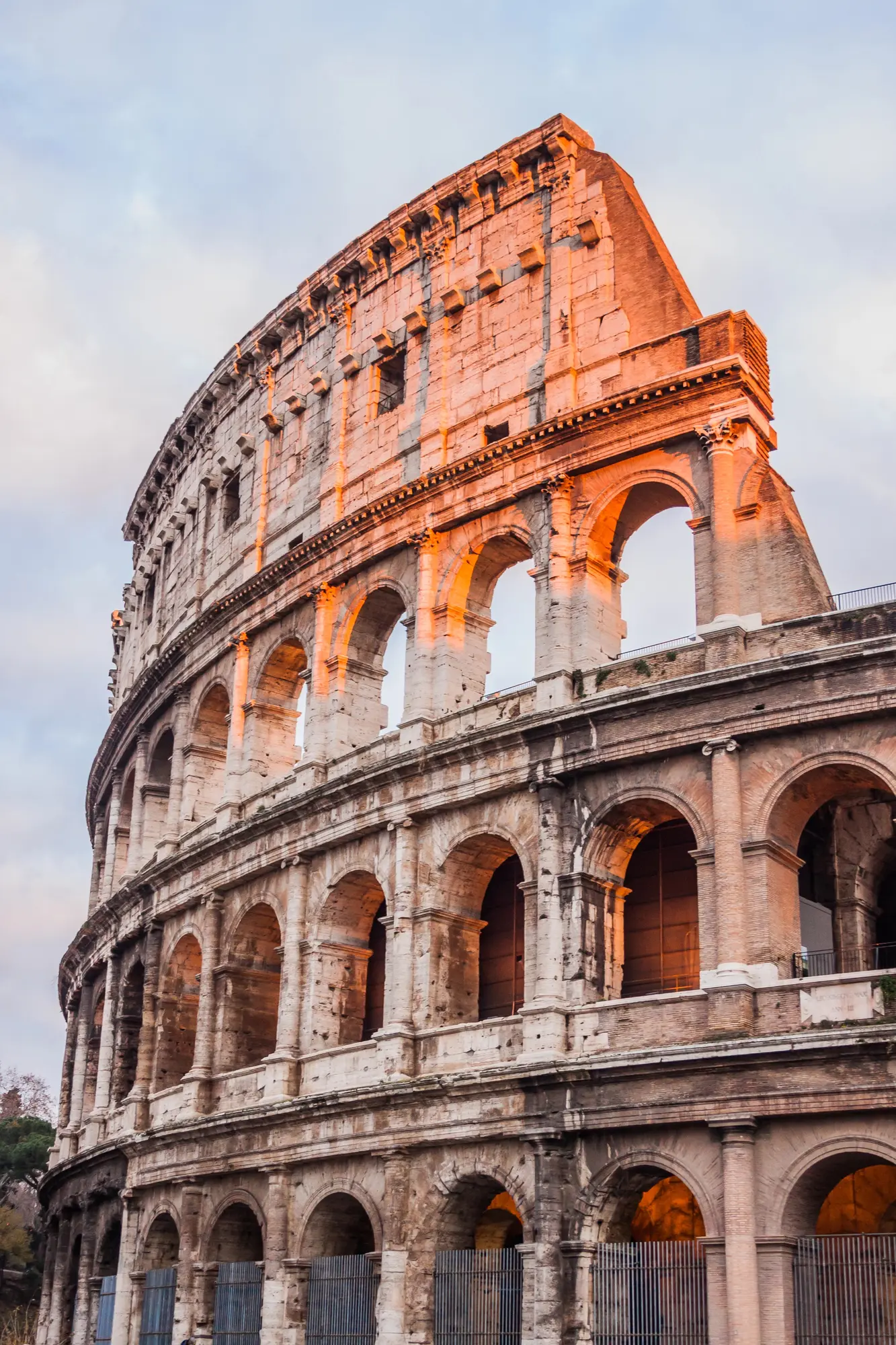 Close up of one side of the Colosseum glowing in the sunset. Is Rome safe?