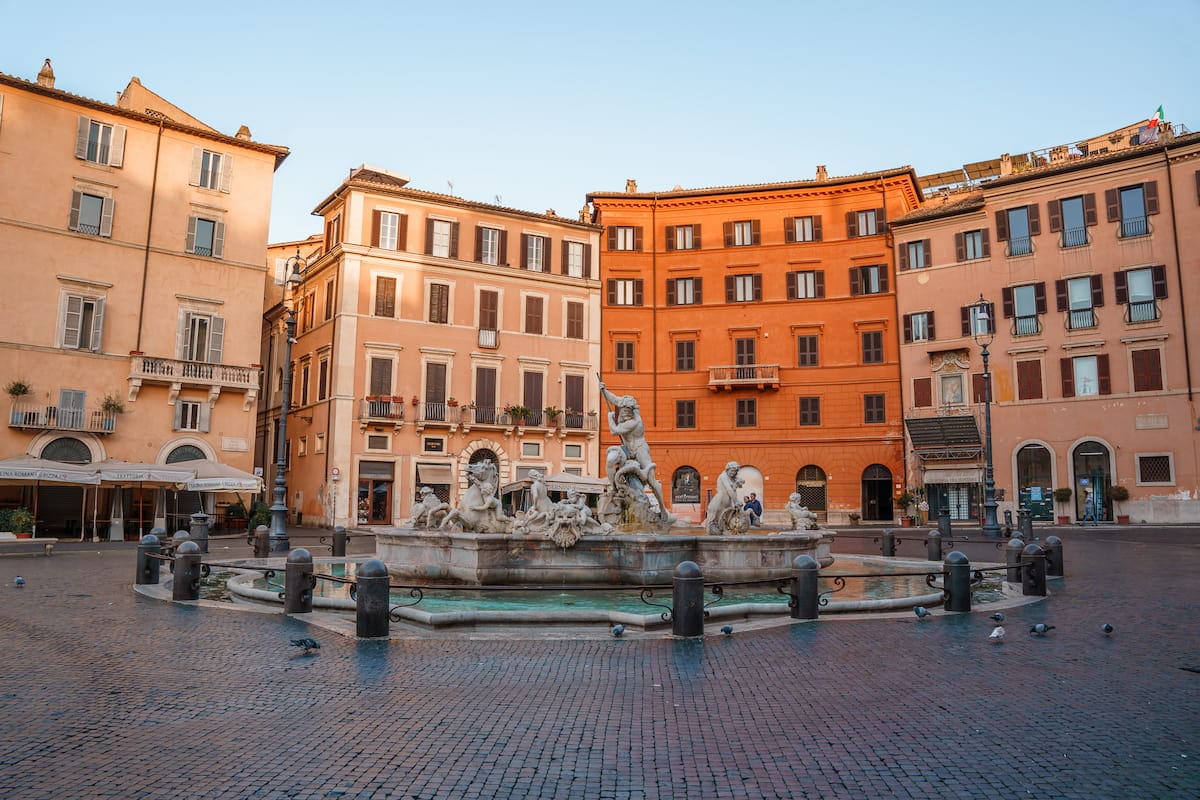 Orange colored buildings surrounding a fountain with statues as Piazza Navona, is Rome safe to visit?