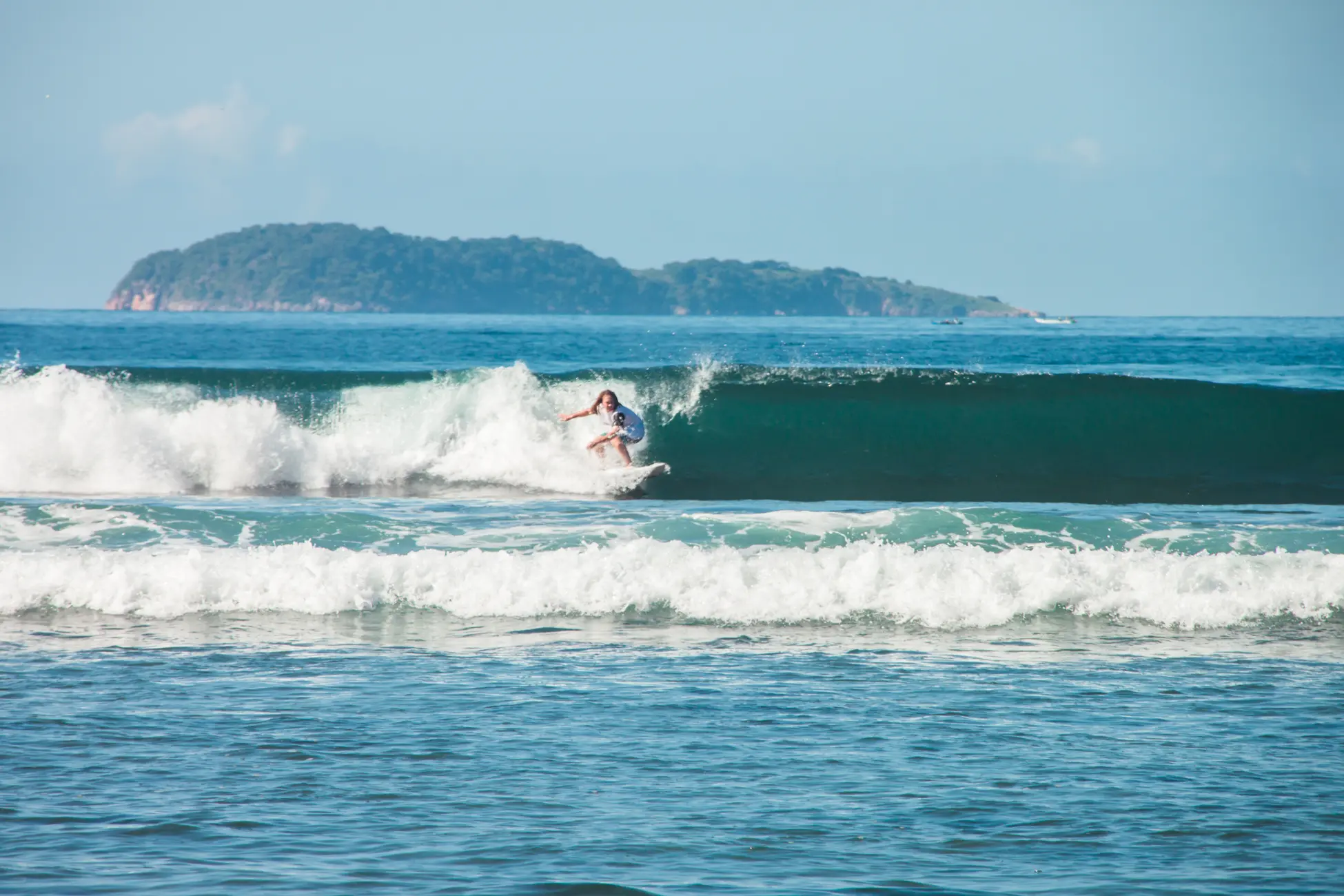 Lone surfer on a wave early in the morning in Kertasari, Sumbawa - Indonesia vs. Thailand