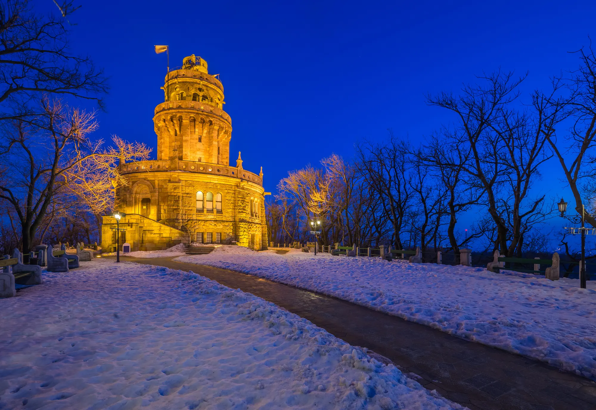 The ornate tower on Elizabeth Lookout lit up during blue hours, a hidden gem in Budapest.