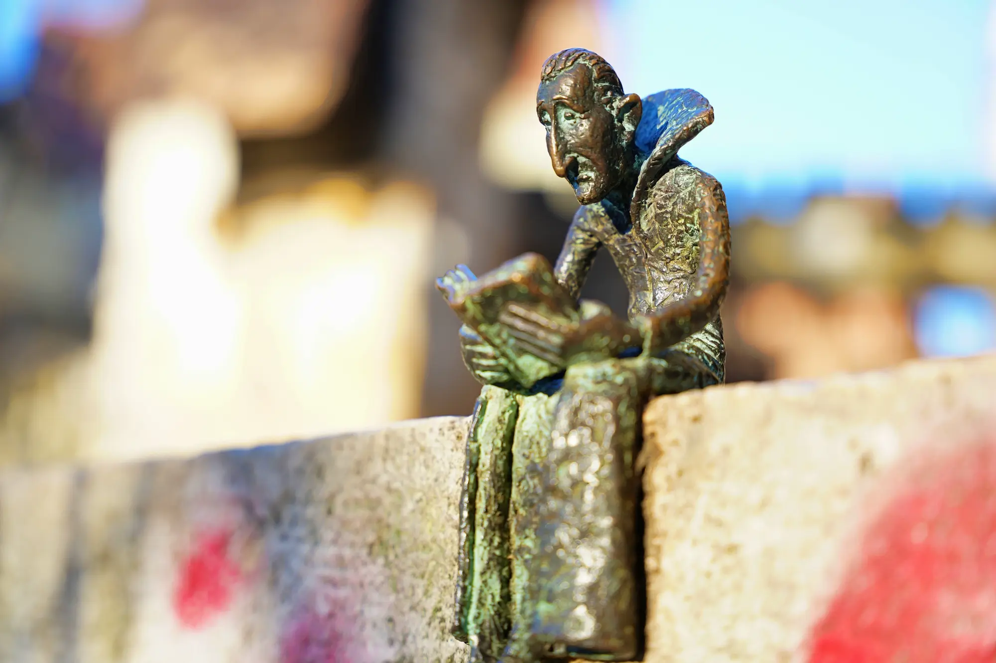 Mini statue of Dracula sitting on the book while reading a book made by artist Kolodko, a hidden gems in Budapest.