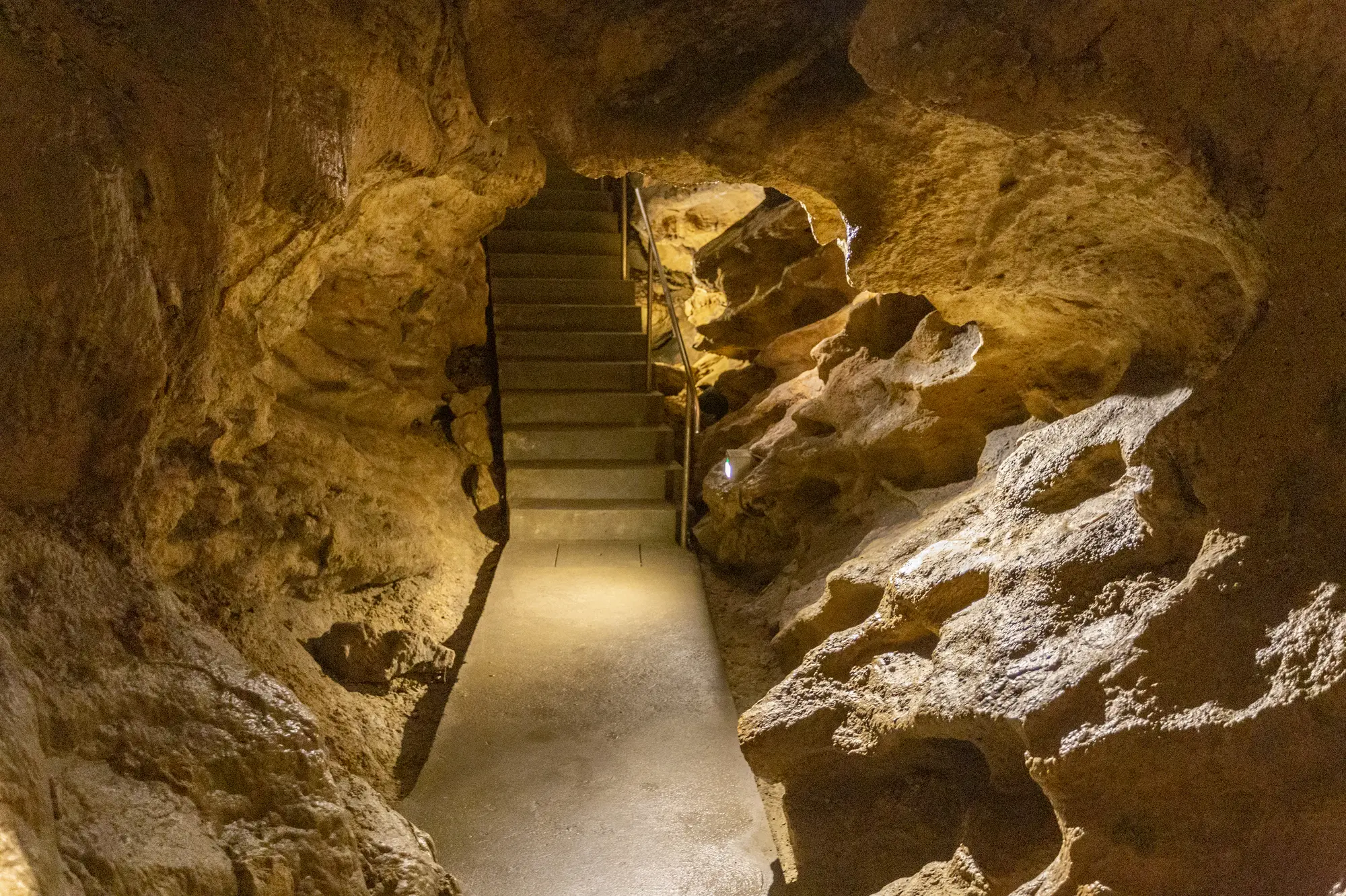 A paved walkway and stair inside Palvolgyi Cave, a hidden gem in Budapest.
