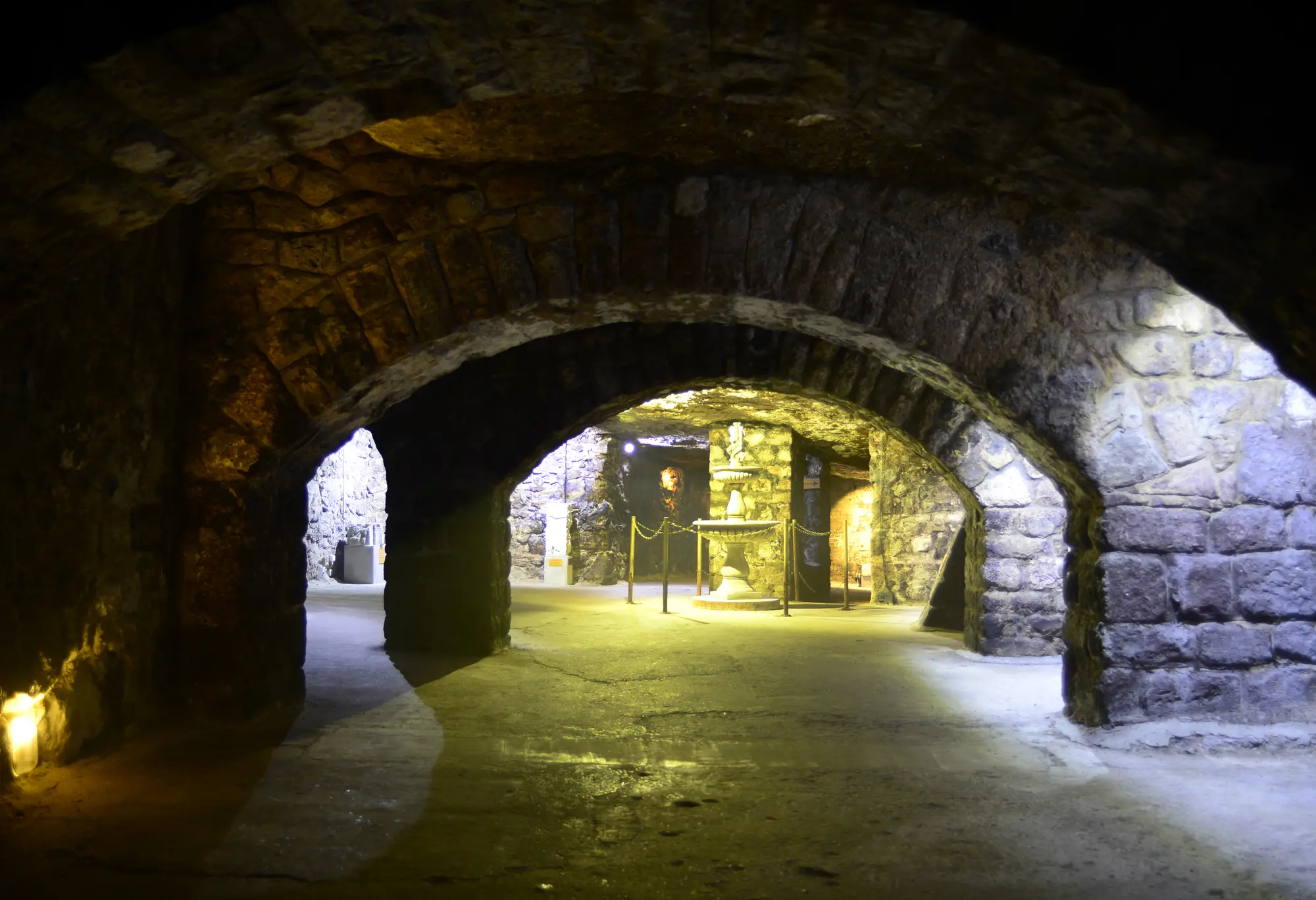 Stone arches over the walkways of the labyrinth under Buda Castle, a hidden gem in Budapest.