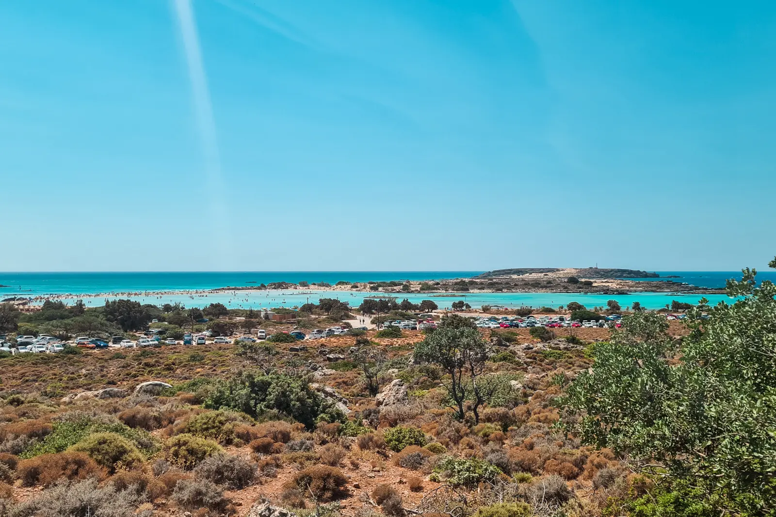 Looking down towards Elafonisi Beach parking and the ocean on a sunny day.