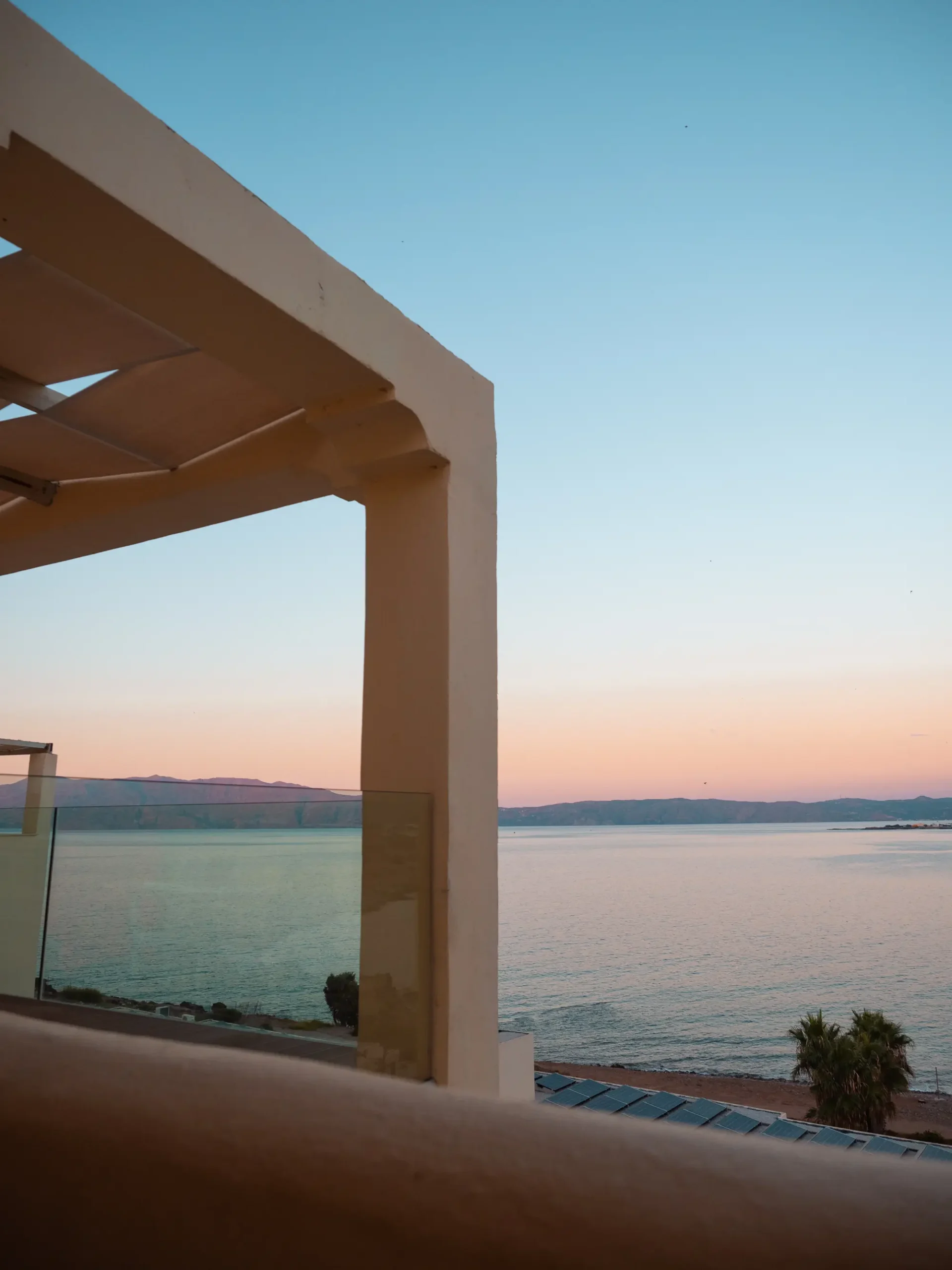 Pastel colored sunset over the ocean seen from veranda close to Balos Lagoon and Falassarna Beach in Crete.