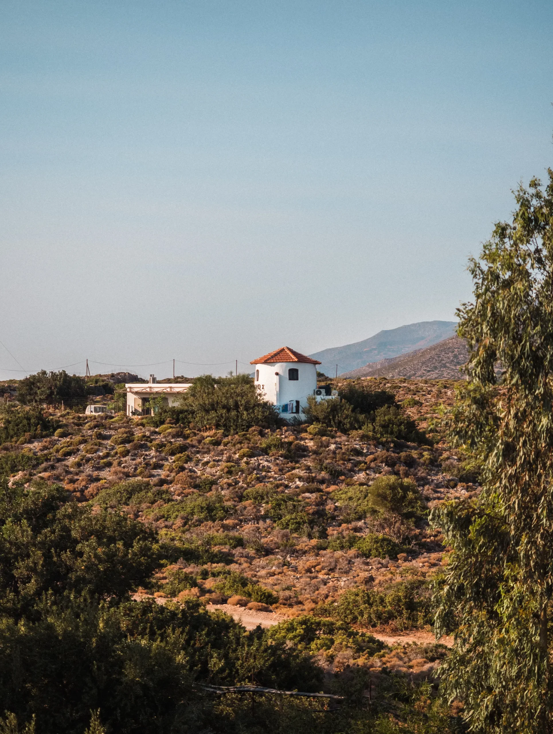 View of a white Greek house surrounded by greenery from the balcony at Elafonisi Beach Resort by Kalomirakis Family.