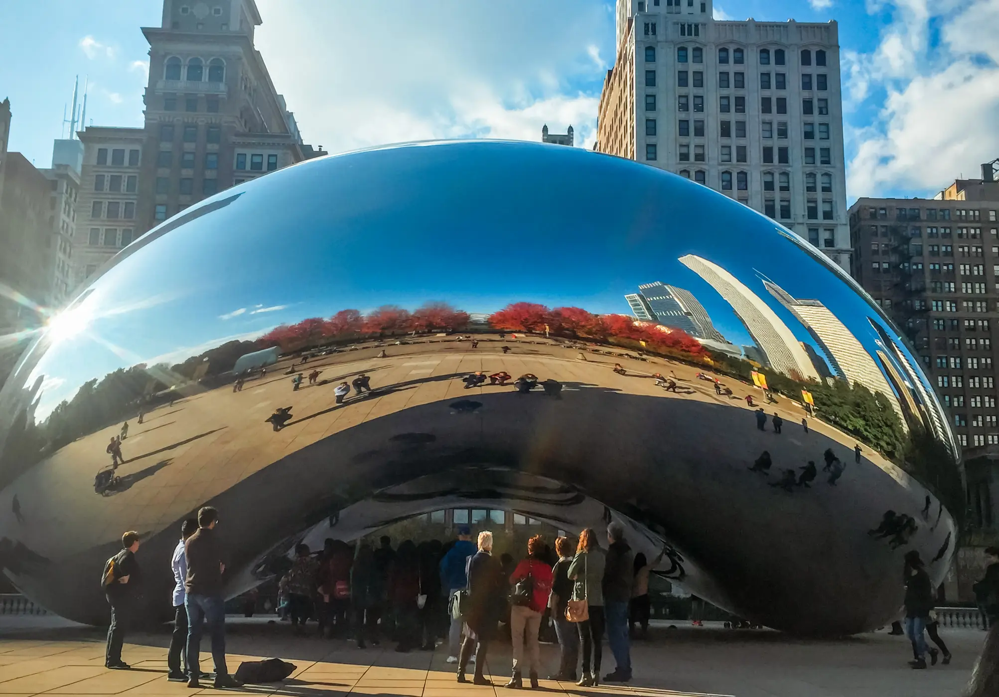 People standing in front of the silver reflecting Bean sculpture in Millennium Park, one of the best things to do during your weekend in Chicago.