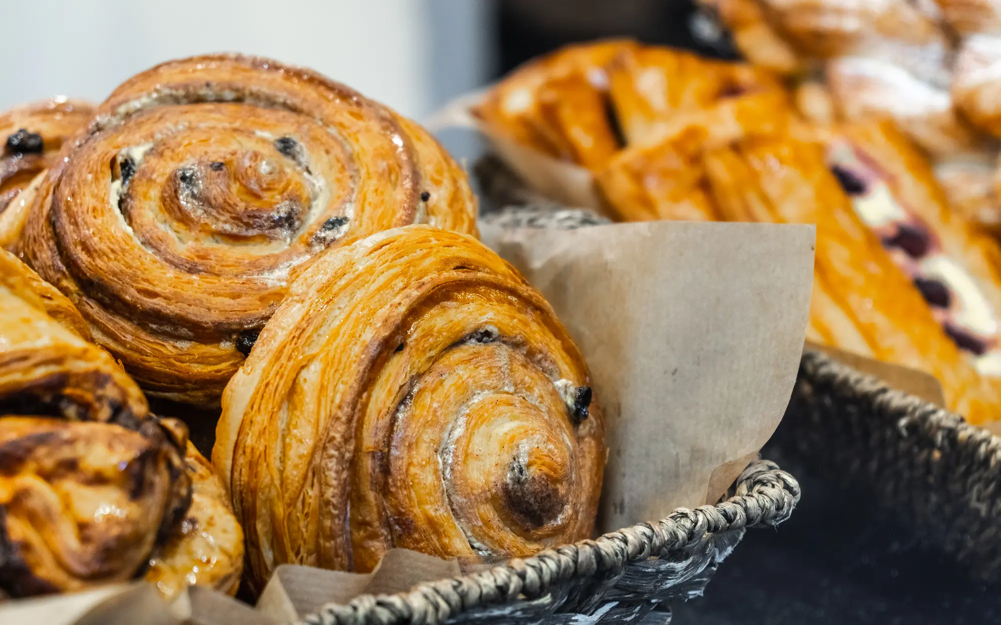 Close up of golden pastries in a basket in a bakery in Wicker Park Chicago.