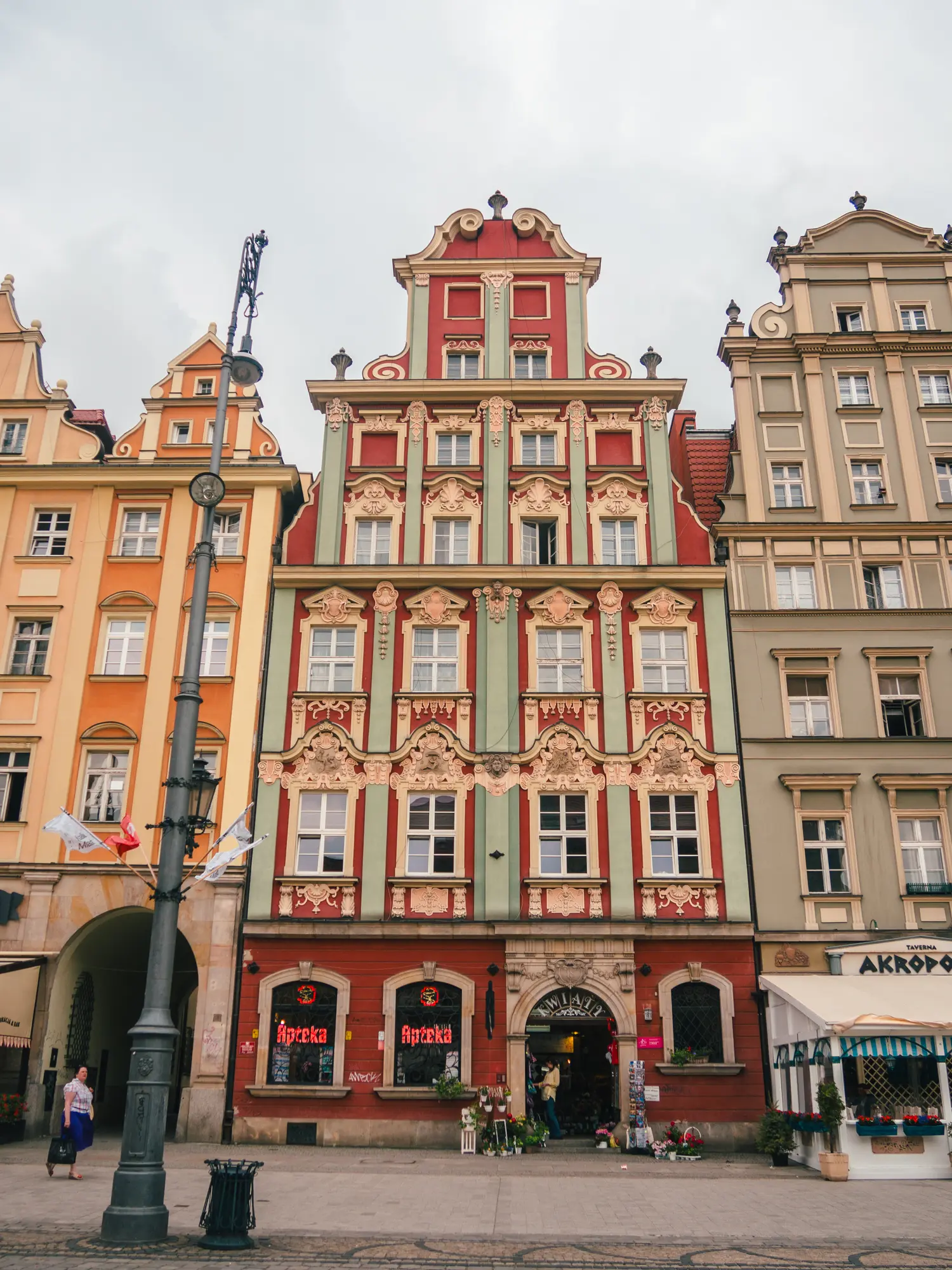 Close up of ornate red, green and gold house in Wroclaw Old Town.