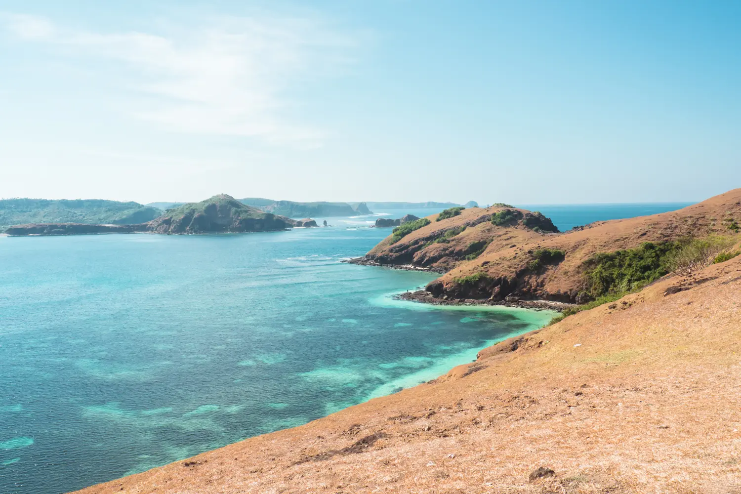 A brown headland snaking into the ocean at Bukit Merese, Lombok or Bali?