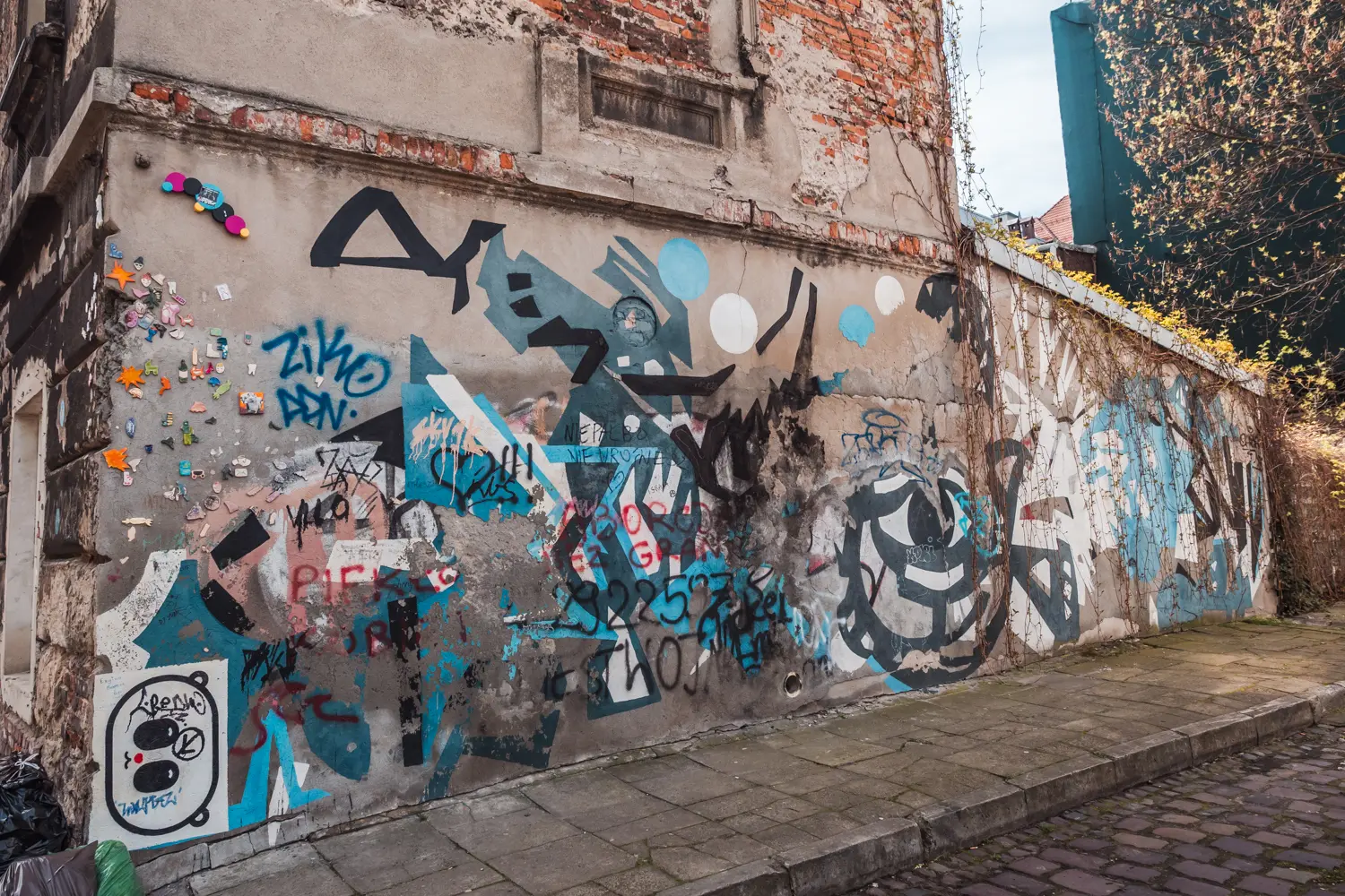 Faded Jewish themed blue, black and white graffiti on a crumbling wall in Kazimierz.