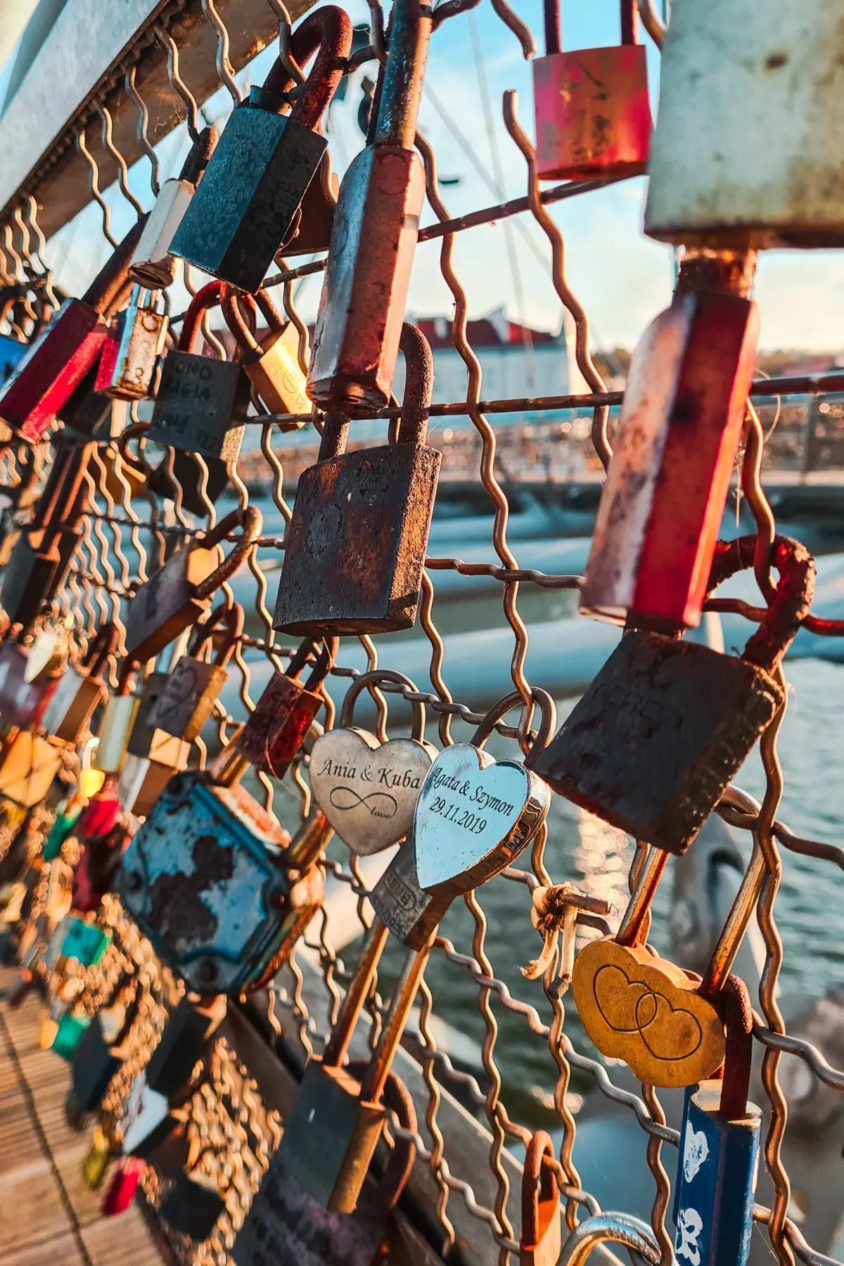 Red, green and rusty engraved love locks on Father Bernatek’s Bridge during a weekend 2 days in Krakow.