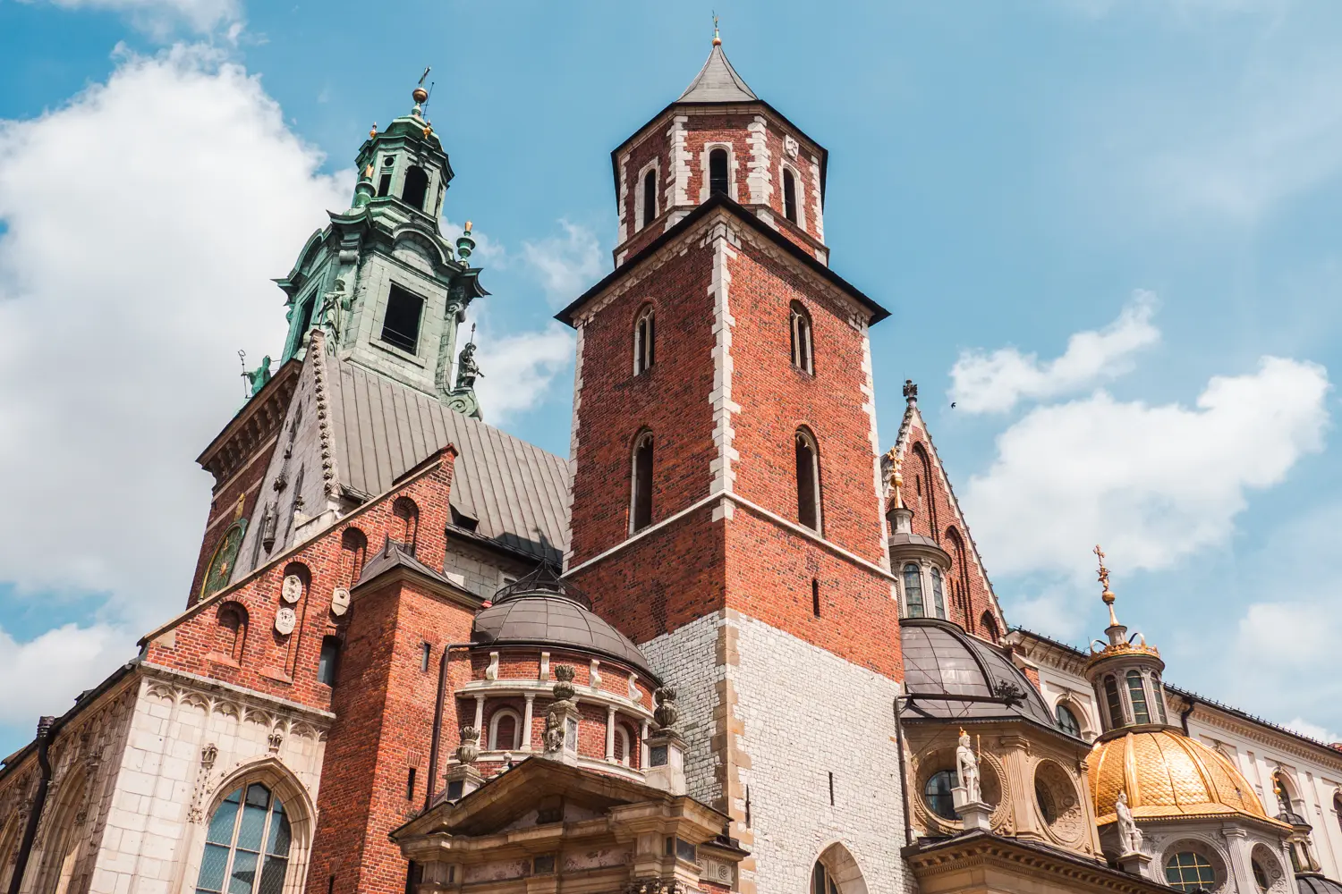 Close up of the red brick towers and domes of Wawel Cathedral at Wawel Castle on a sunny day in Krakow.