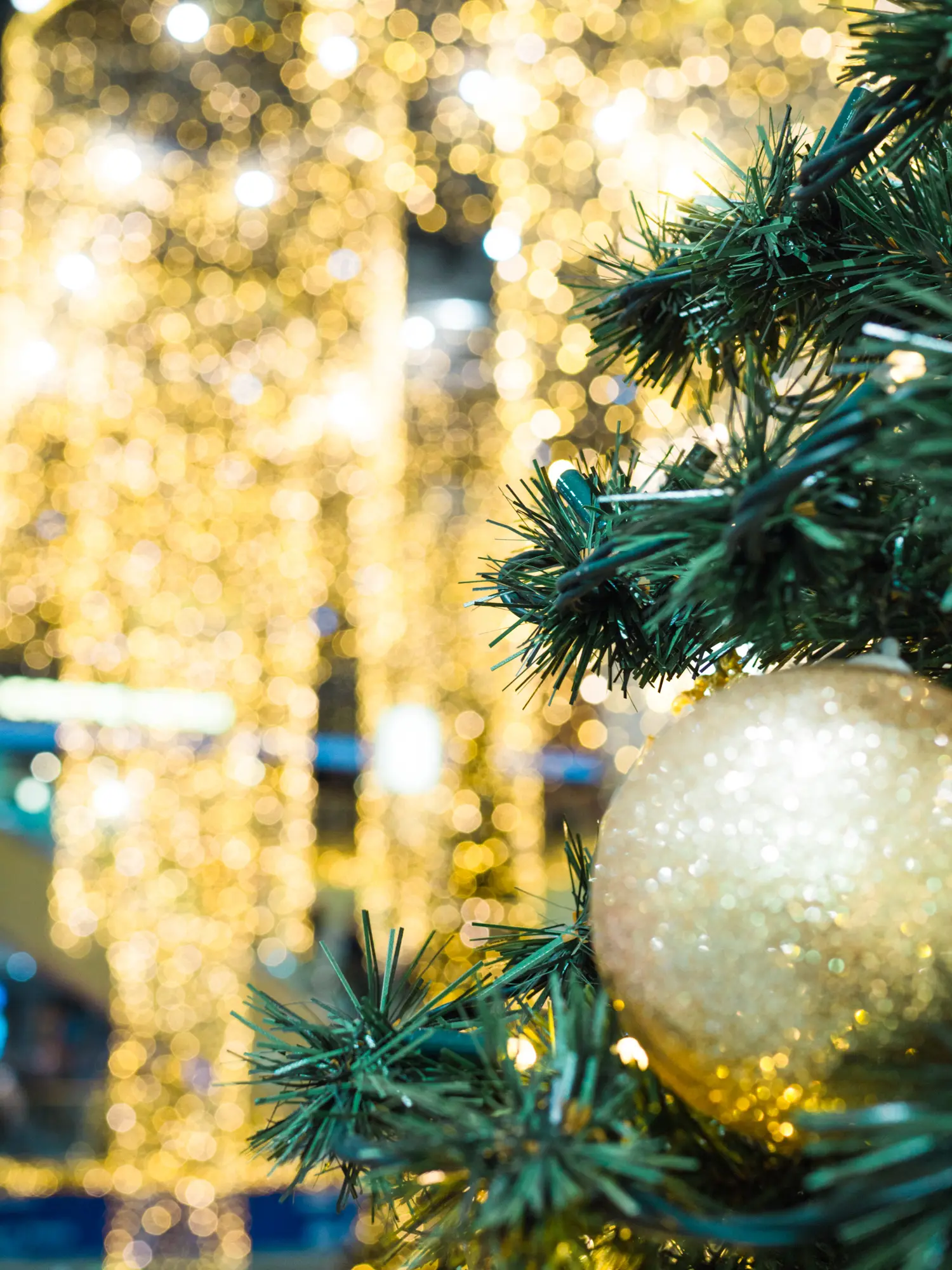 Close up of a gold ornament on a Christmas tree at a shopping mall in Krakow.