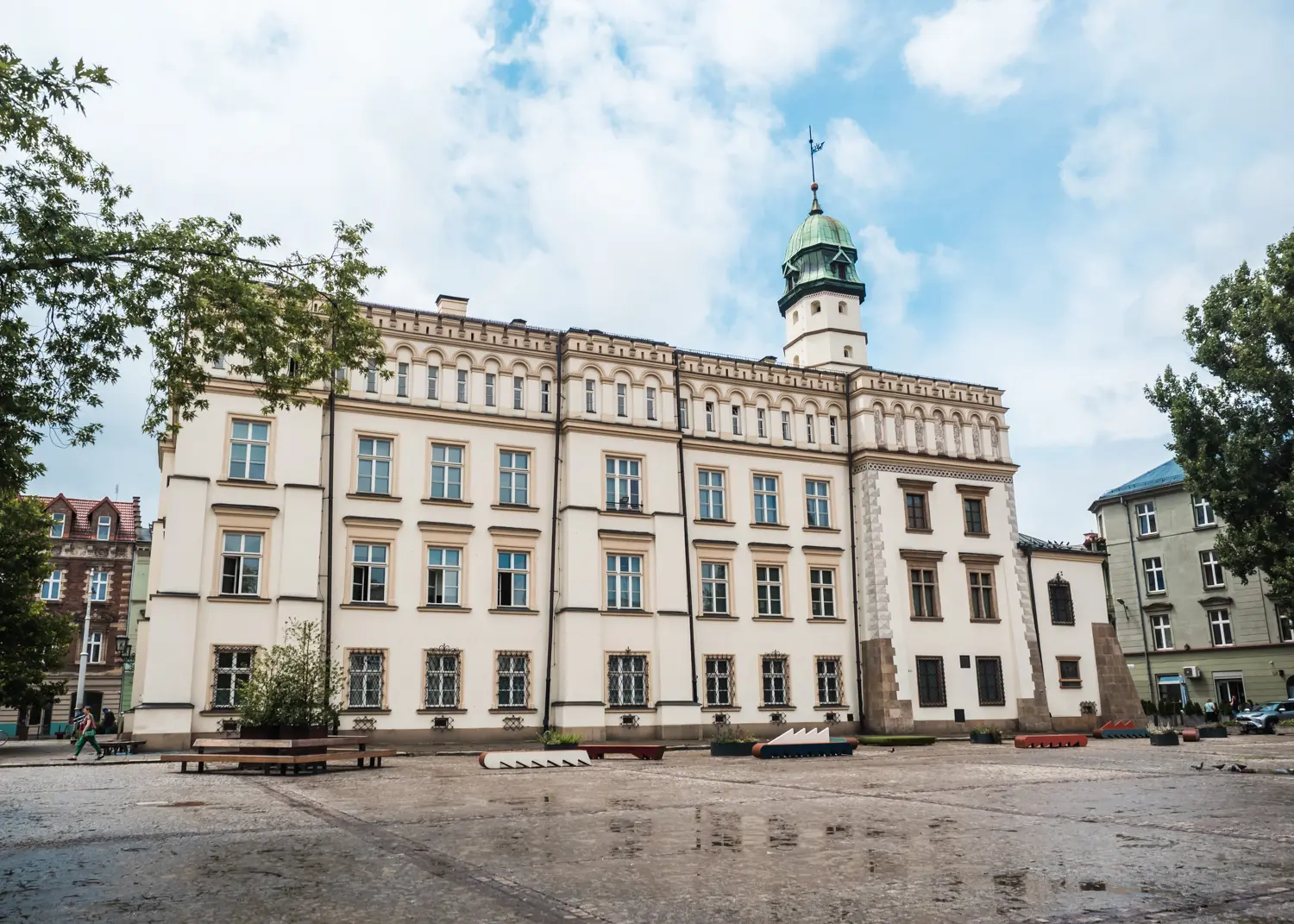 A rectangle old-style building with a tower on the right side, home to the Ethnographic Museum, one of the hidden gems in Krakow.